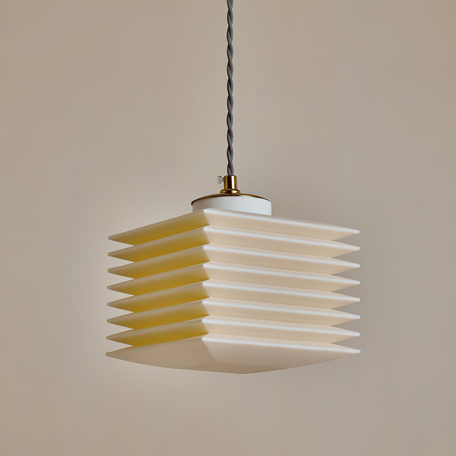 The Pagoda Pendant Lamp illuminated, showing its geometric form.