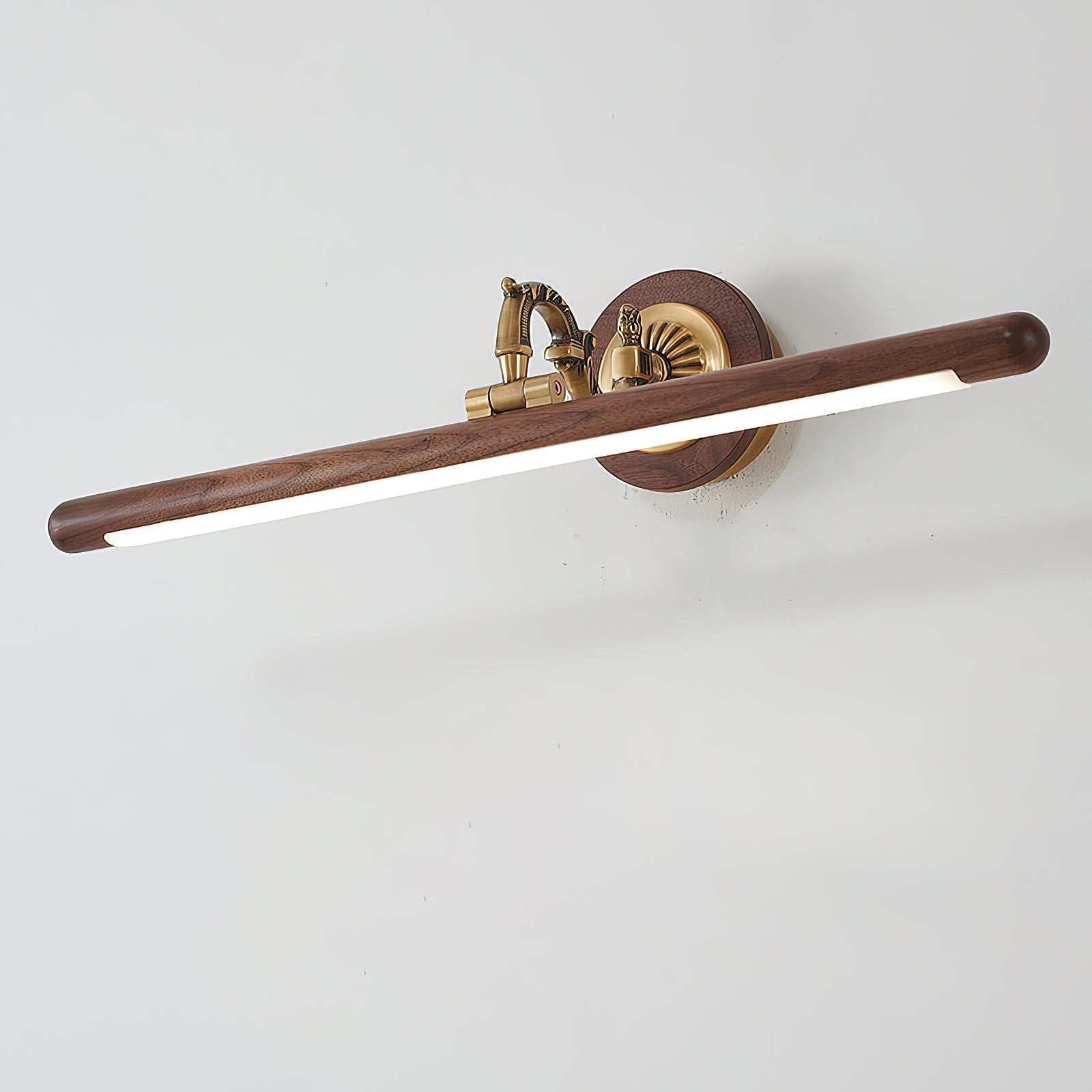 Angled shot of the walnut and brass picture light.