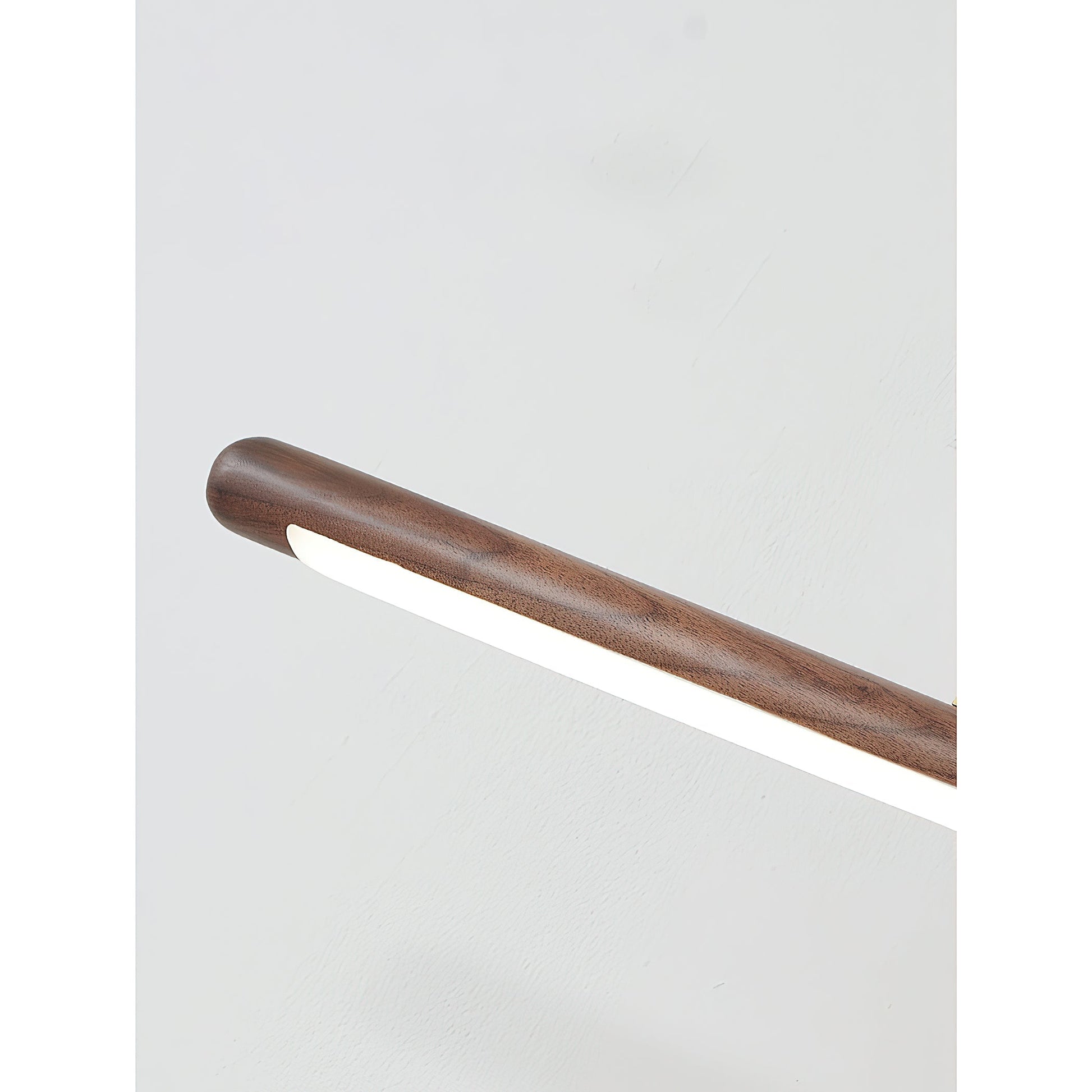 The white picture light mounted on a dark-colored wall for contrast.