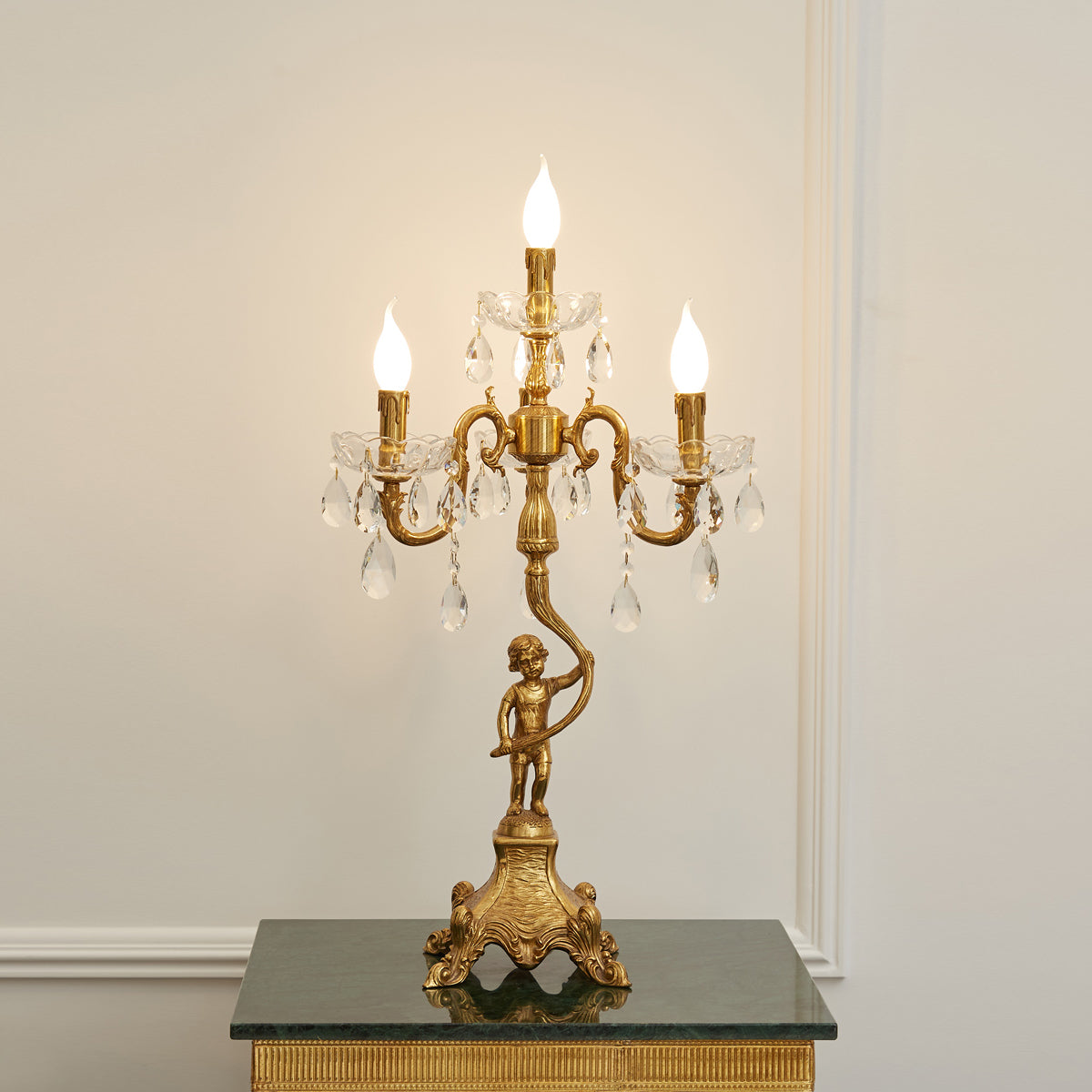 Focus on the intricate crystal pieces hanging from the lamp's arms.