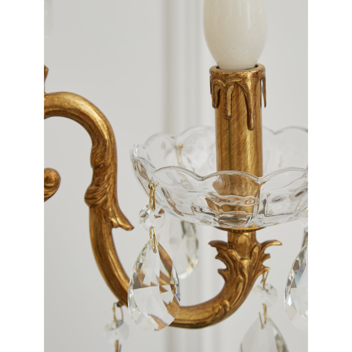 Lifestyle image of the candlestick lamp providing ambient light in a bedroom.