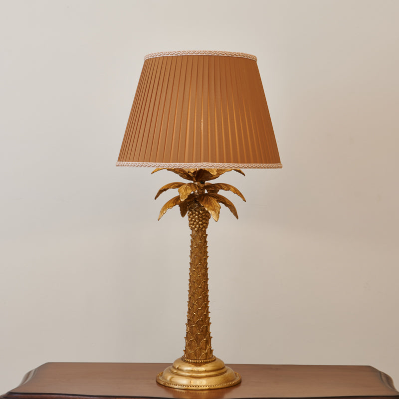 The warm glow from the illuminated fabric shade.