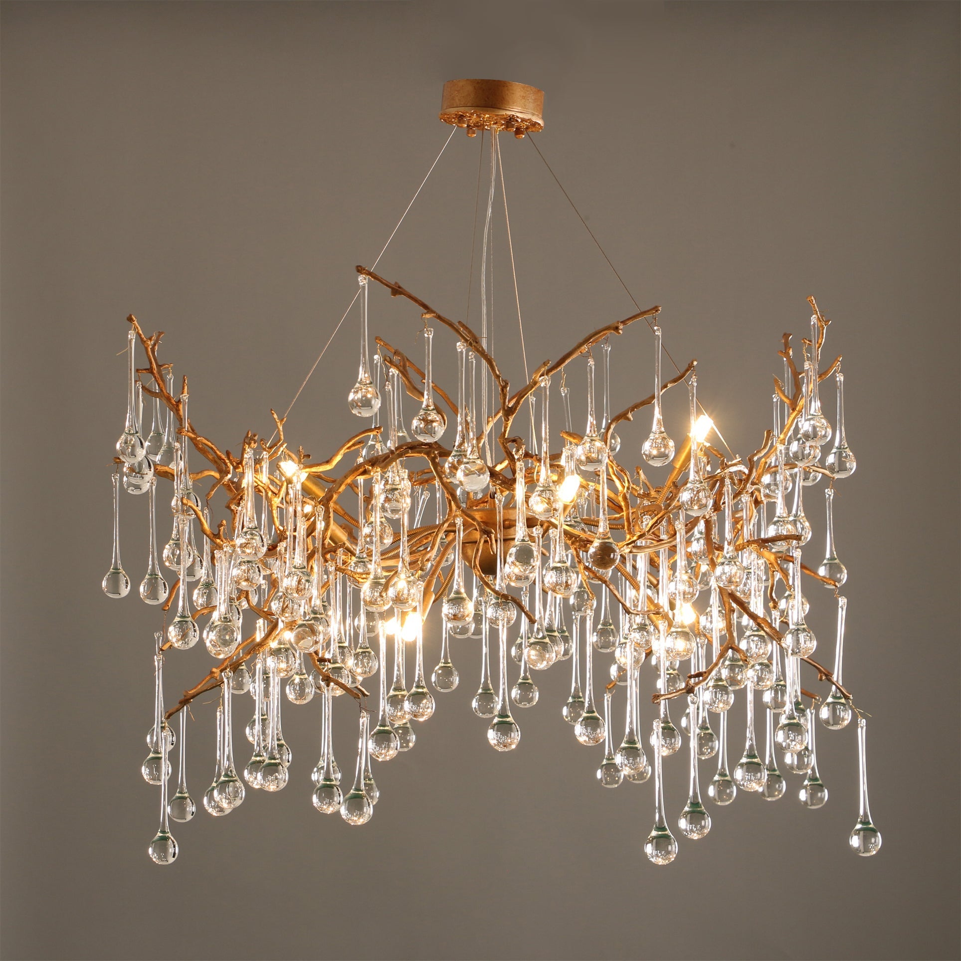 The Palwa Chandelier hanging in a modern living room, casting a warm glow.