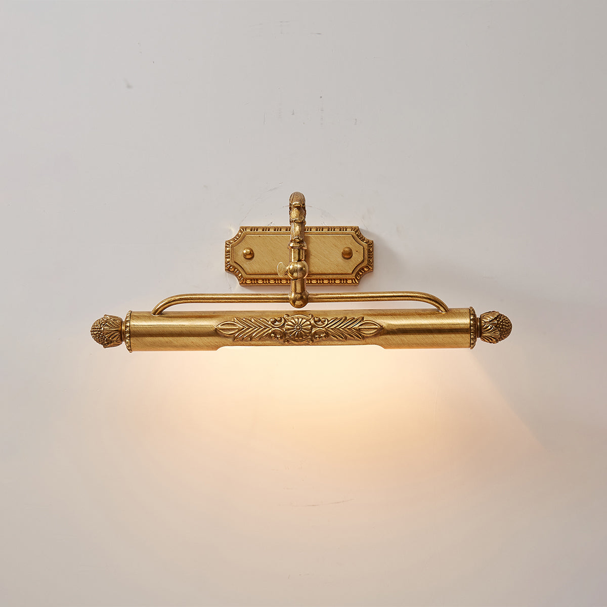 Pania Brass Wall Lamp against a light, neutral wall.