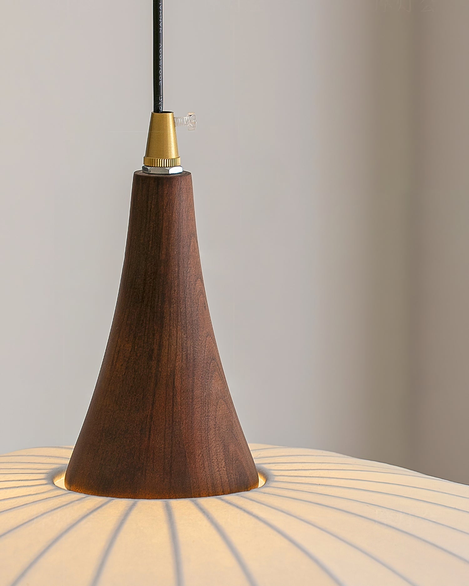 Detail shot of the solid wood base connecting to the fabric shade.