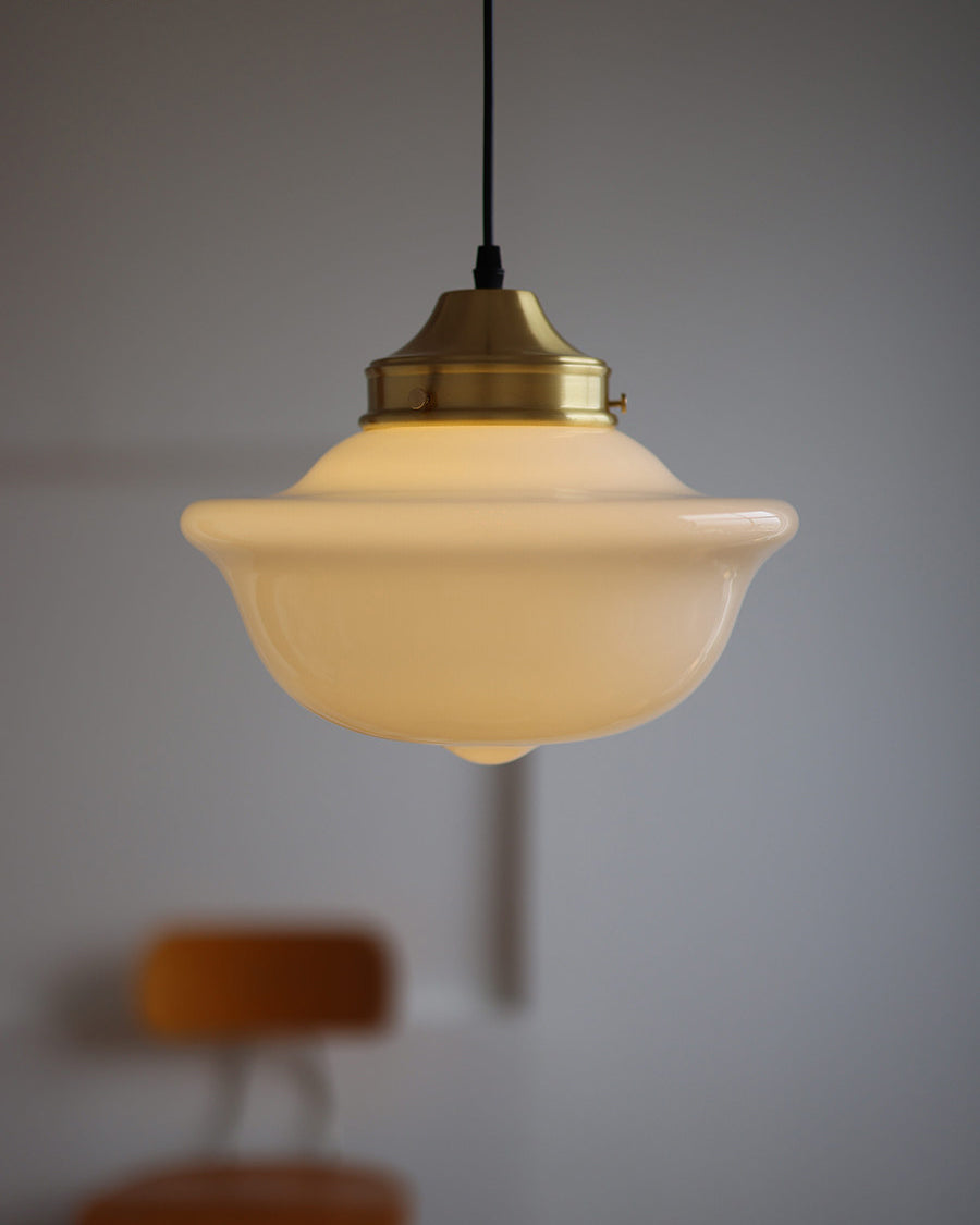 The ceiling canopy and suspension wire of the pendant light.