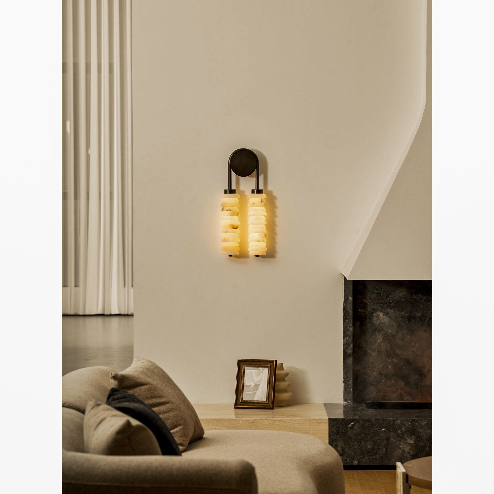 The warm, diffused light emitted from the natural alabaster shades.