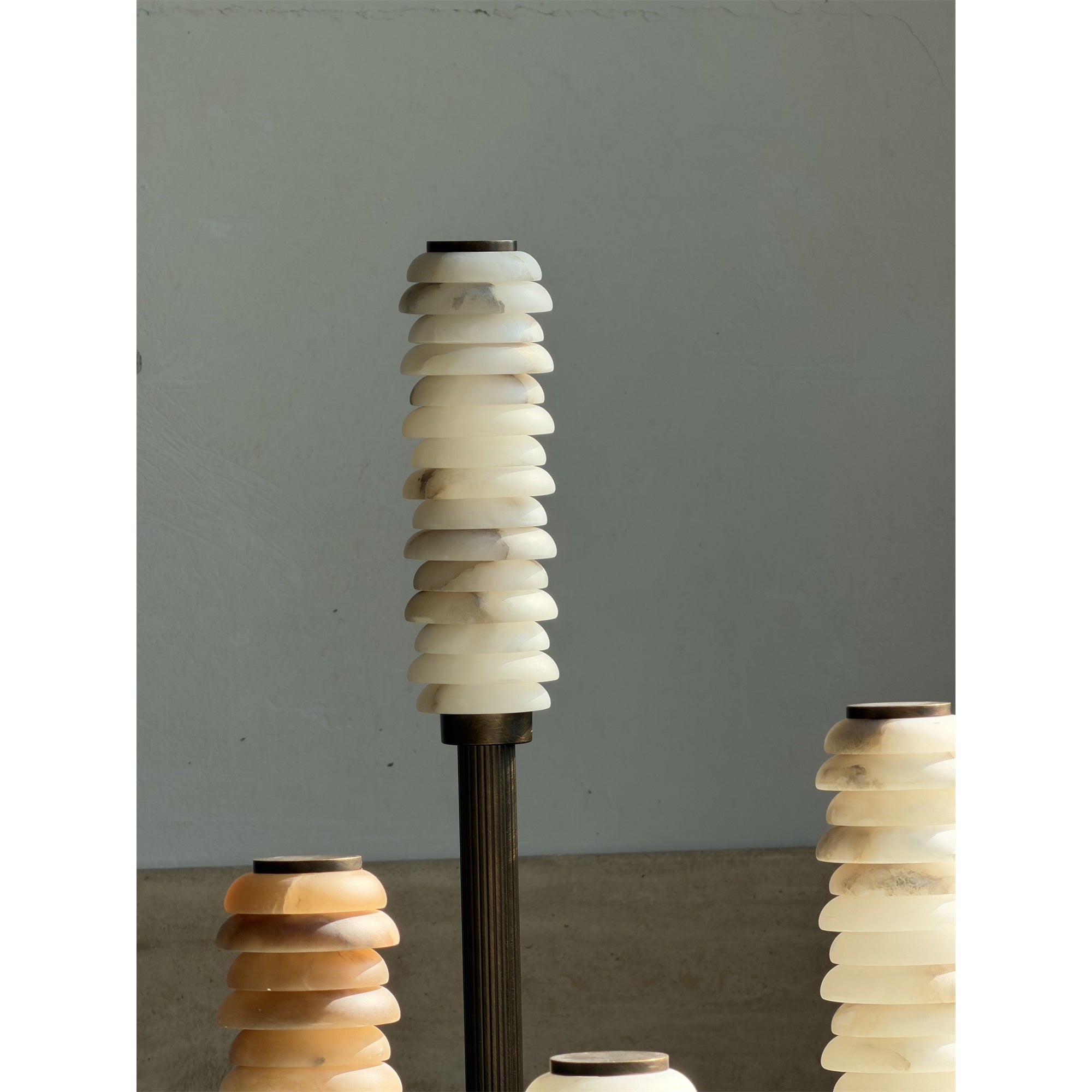 Payson Alabaster Floor Lamp next to a modern armchair.