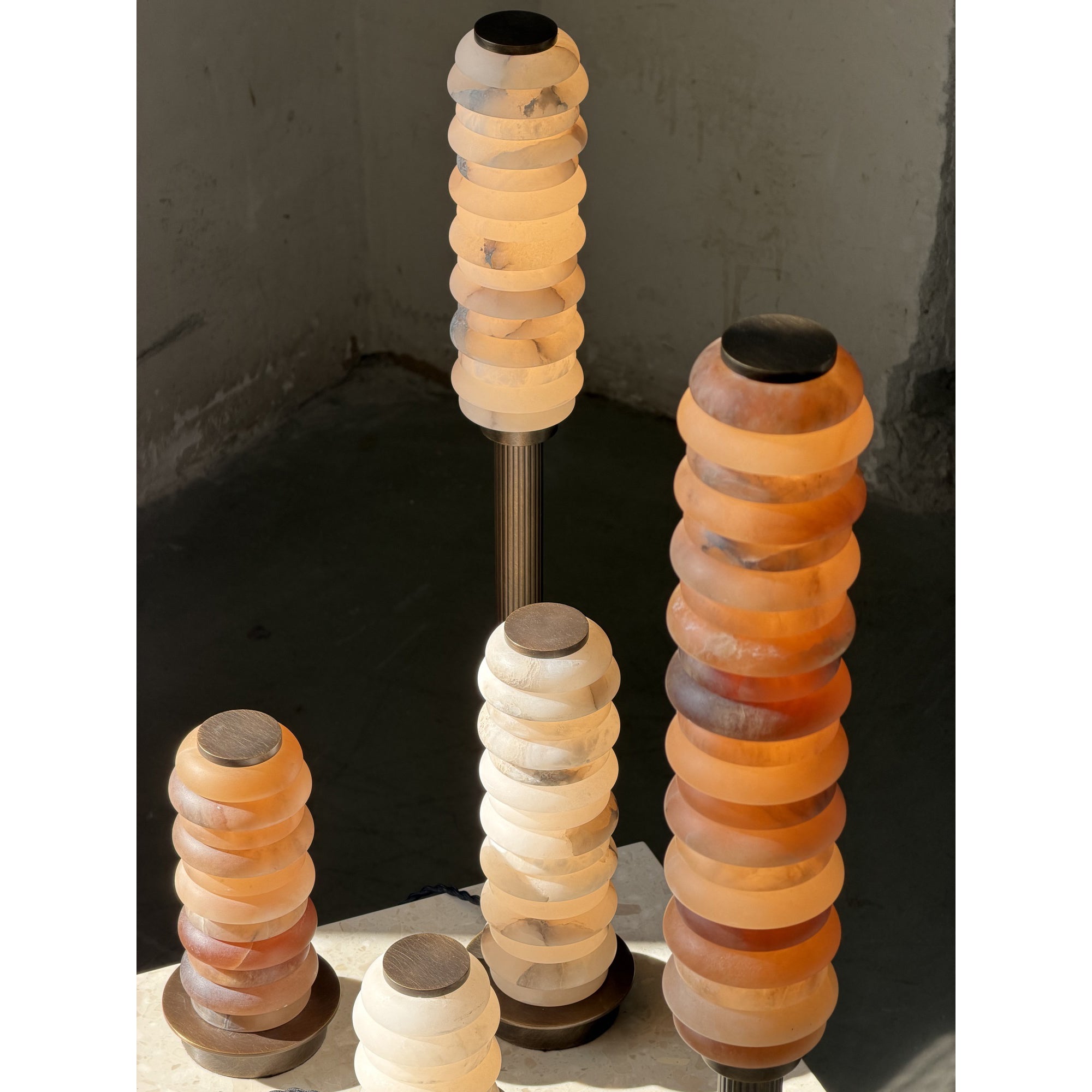 The white finish Payson Alabaster Table Lamp on a white surface.