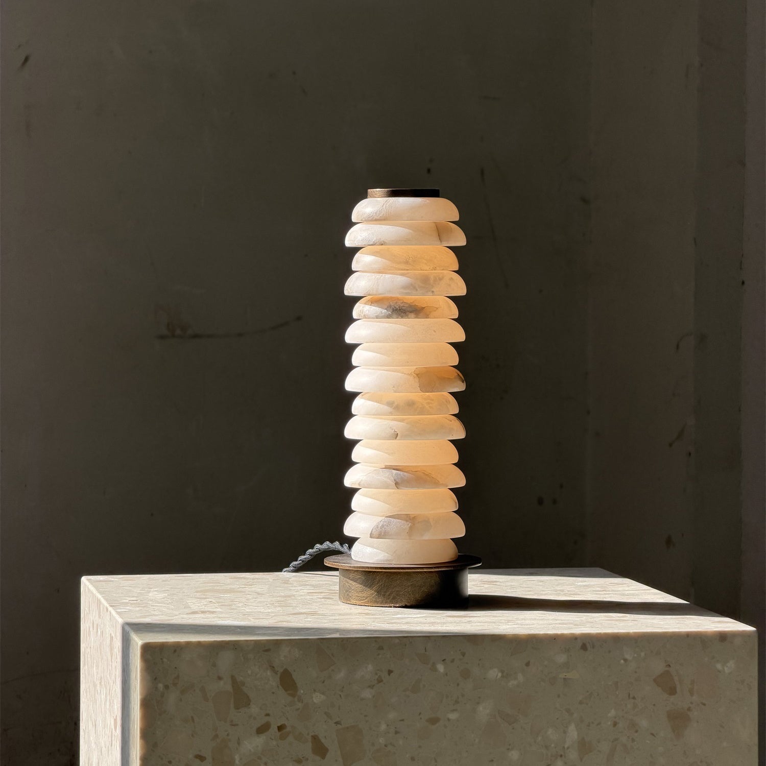 Payson Alabaster Table Lamp on a living room side table.