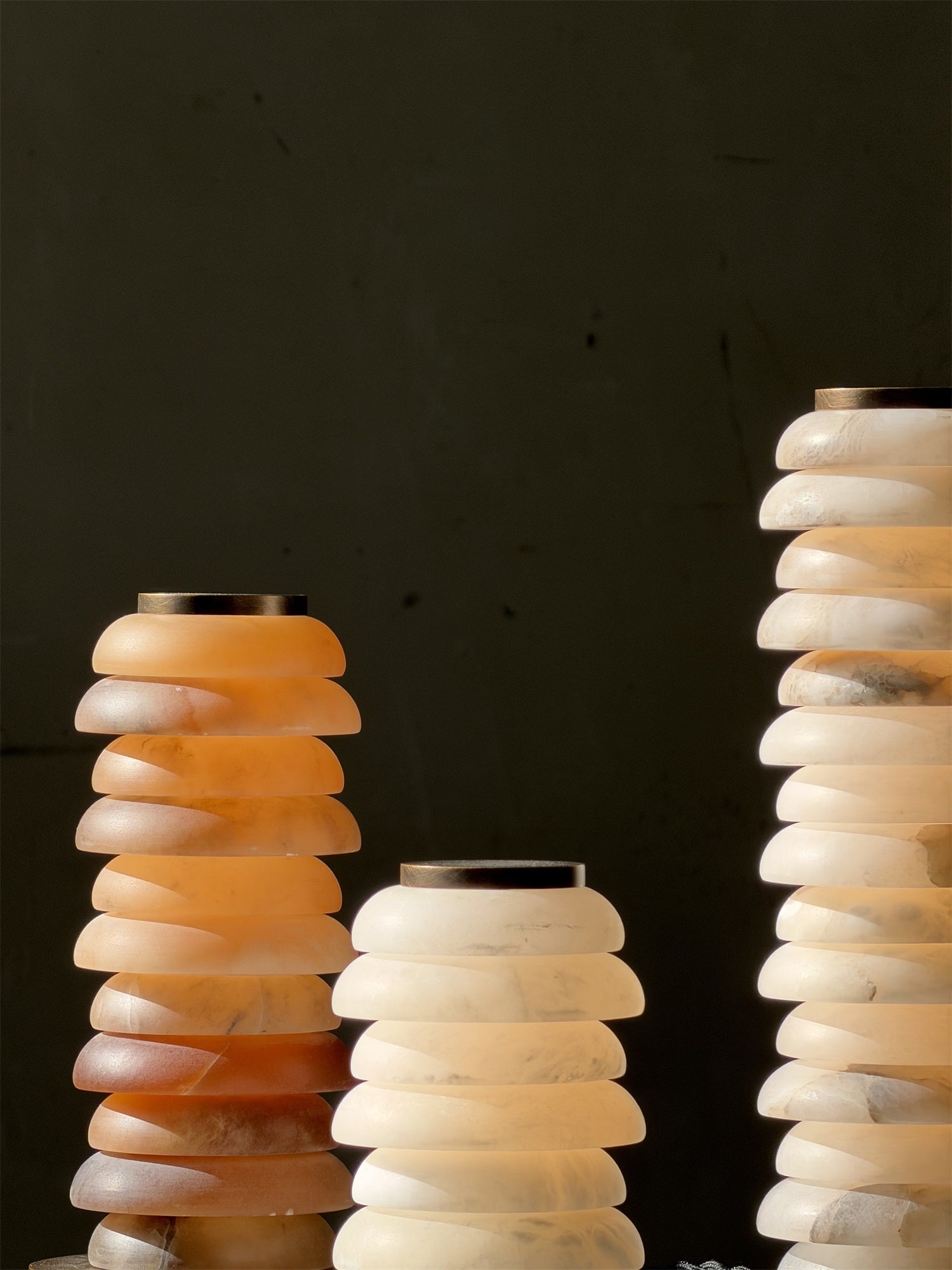 The brown finish Payson Alabaster Table Lamp against a dark background.