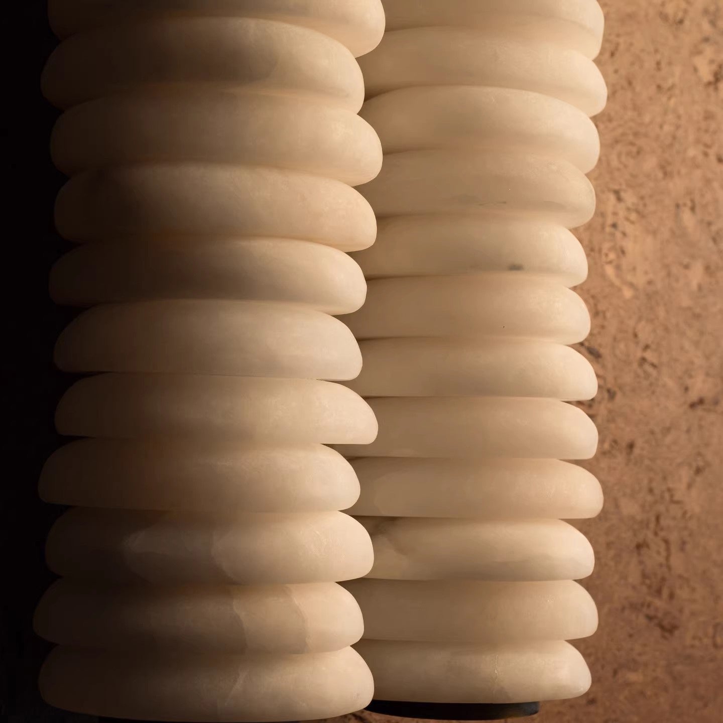 Lifestyle image of the wall lamp in a bedroom above a nightstand.