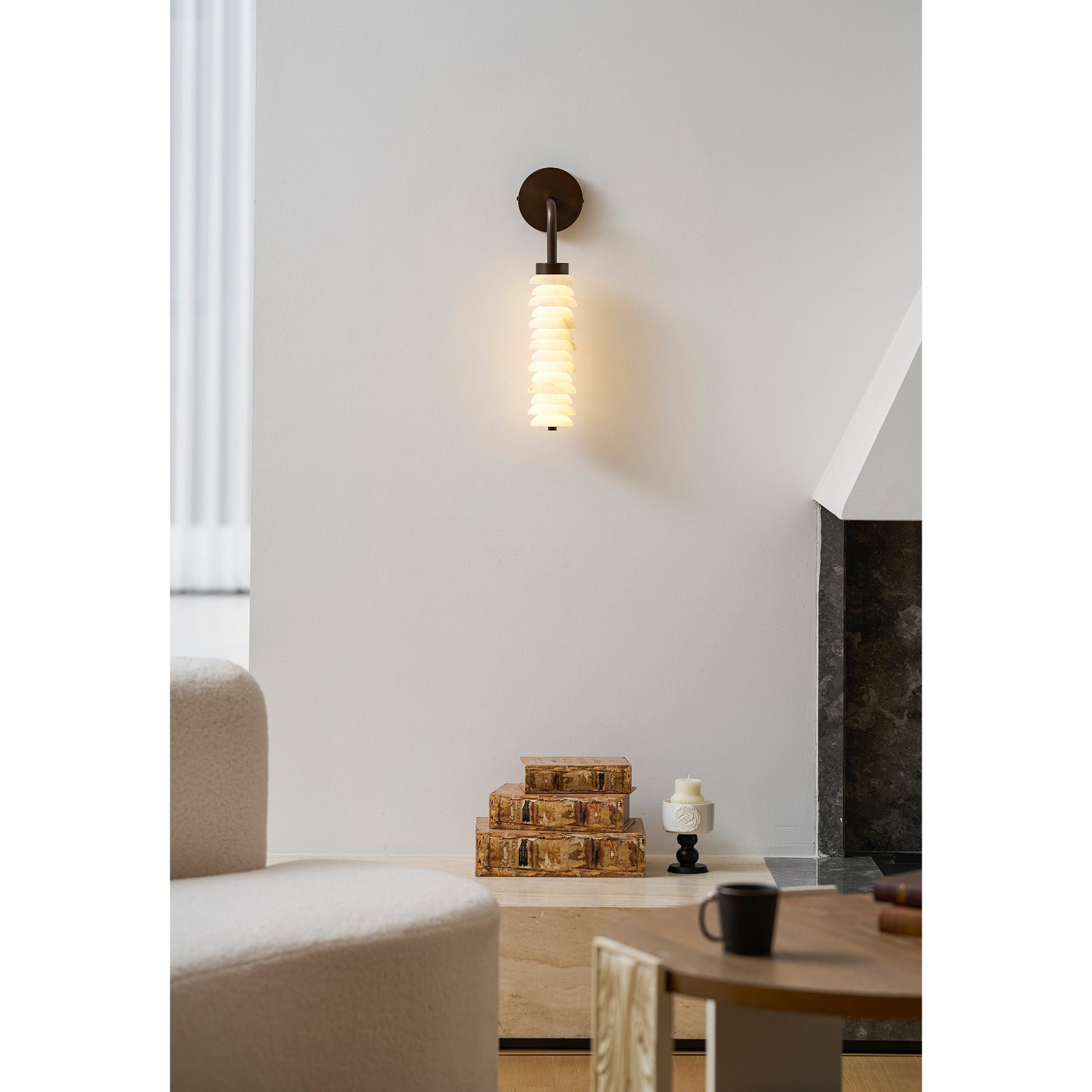 Payson sconce shown in a bedroom above a nightstand.