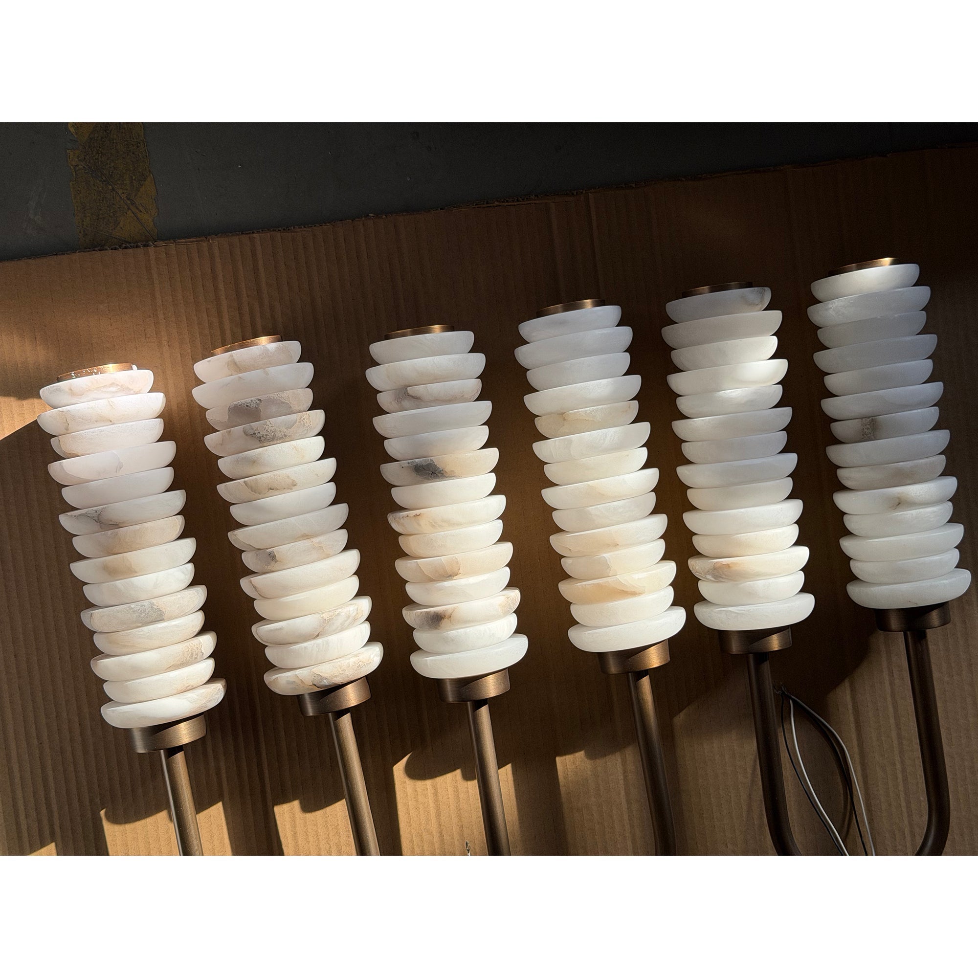 The wall lamp shown in a minimalist hallway.