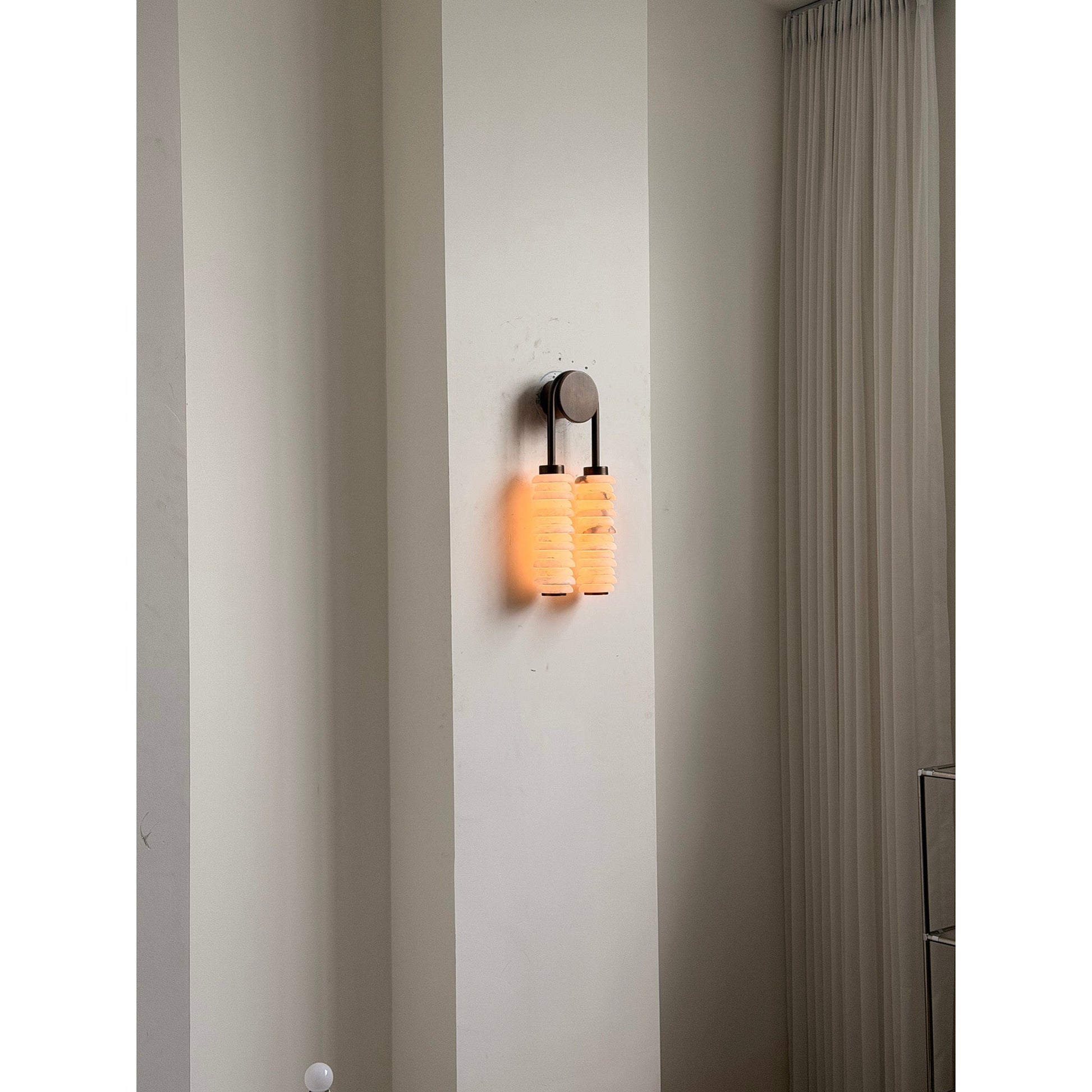 Payson Alabaster Wall Lamp with an antique brass finish.