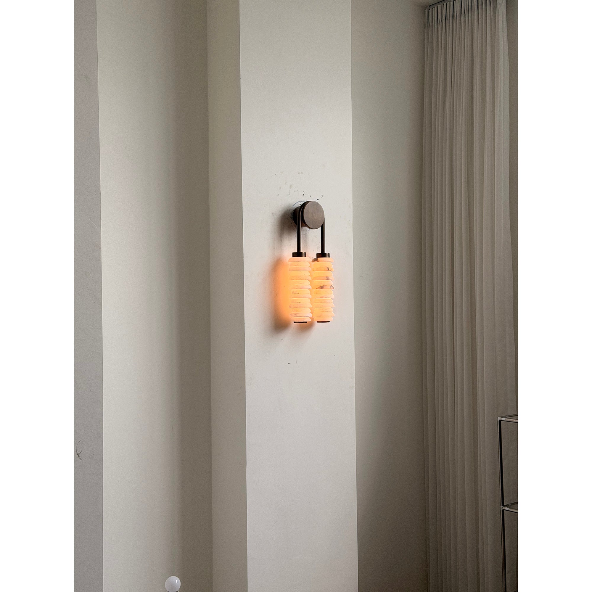 Payson Alabaster Wall Lamp with an antique brass finish.