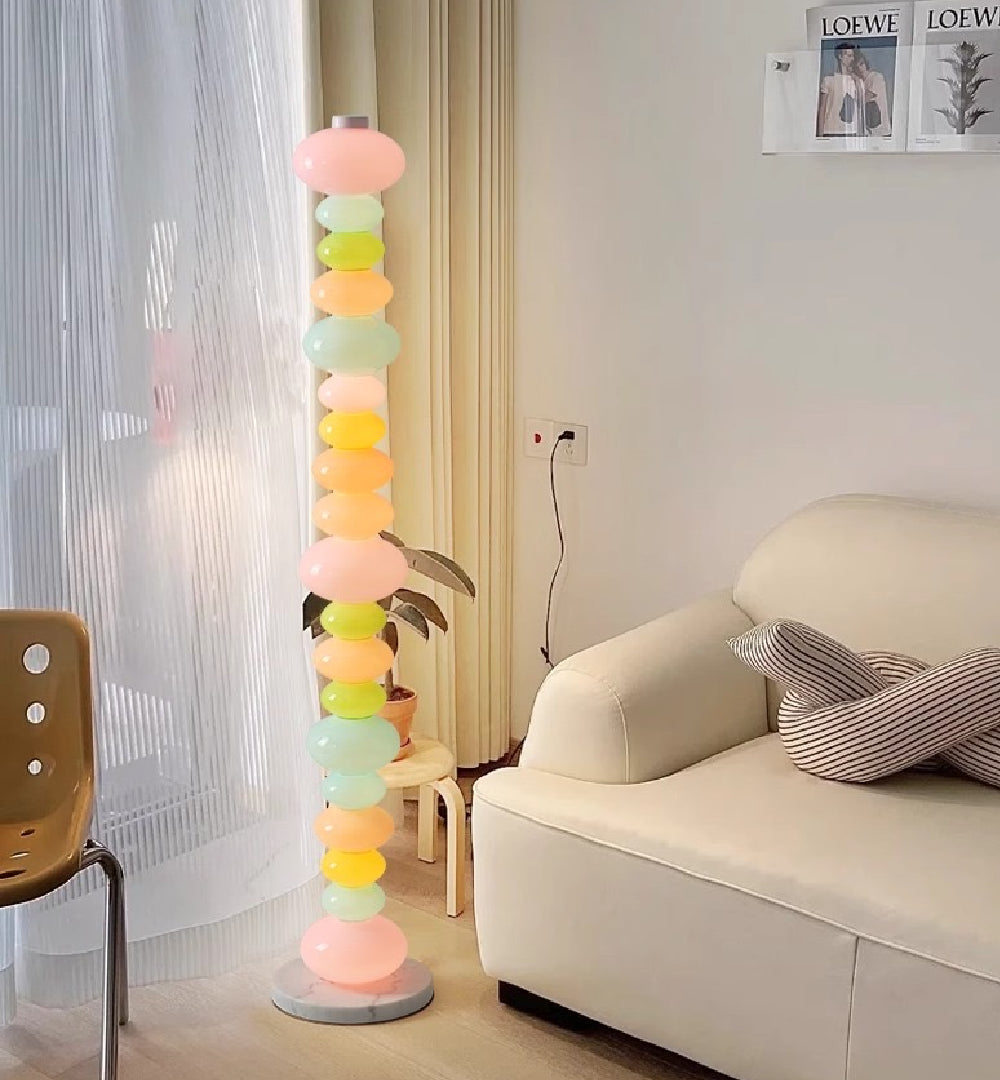 The Green Pebbles Candy Floor Lamp adding a touch of color to a bedroom.