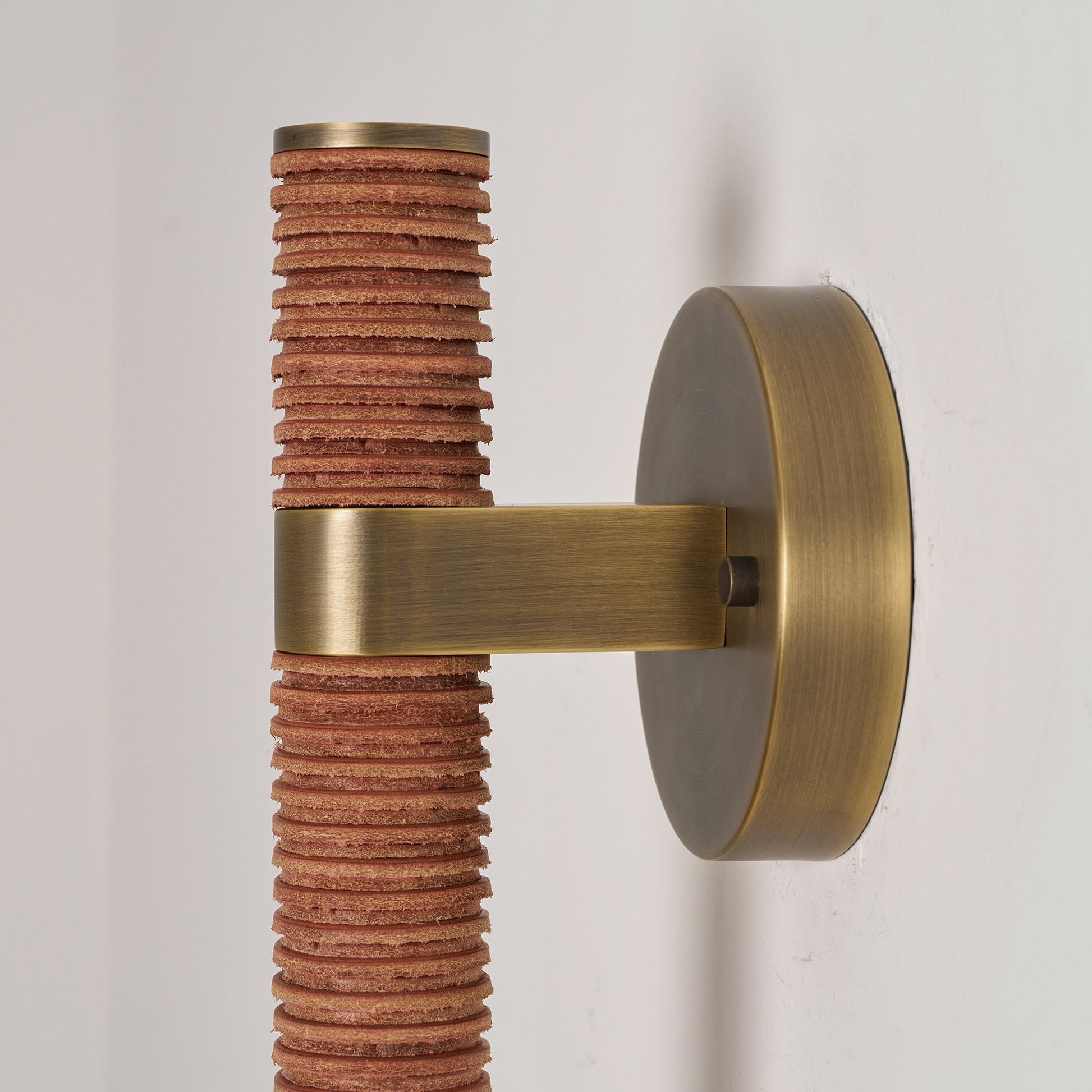Full view of the brown leather Threadline Globe Wall Sconce.