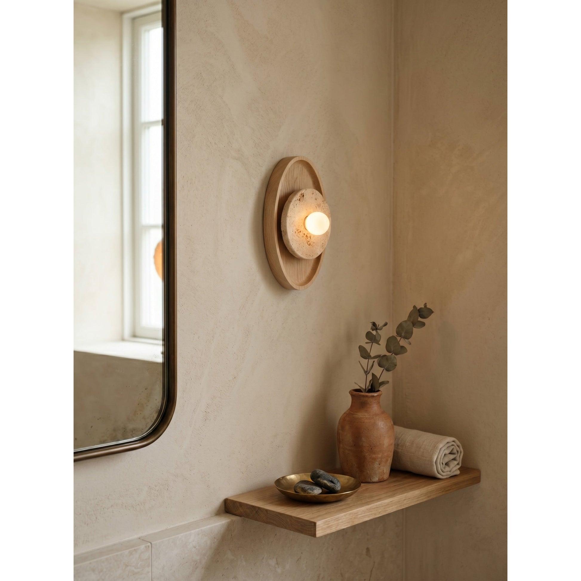 The sconce shown against a dark wall to highlight its form.