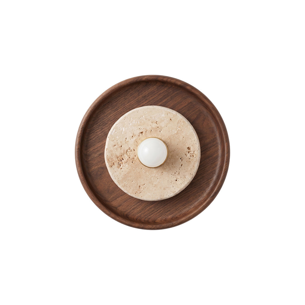 The Petra Travertine Wall Sconce in a hallway setting.