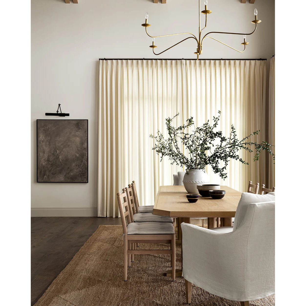 The white Philomena Chandelier in a bright, minimalist room.