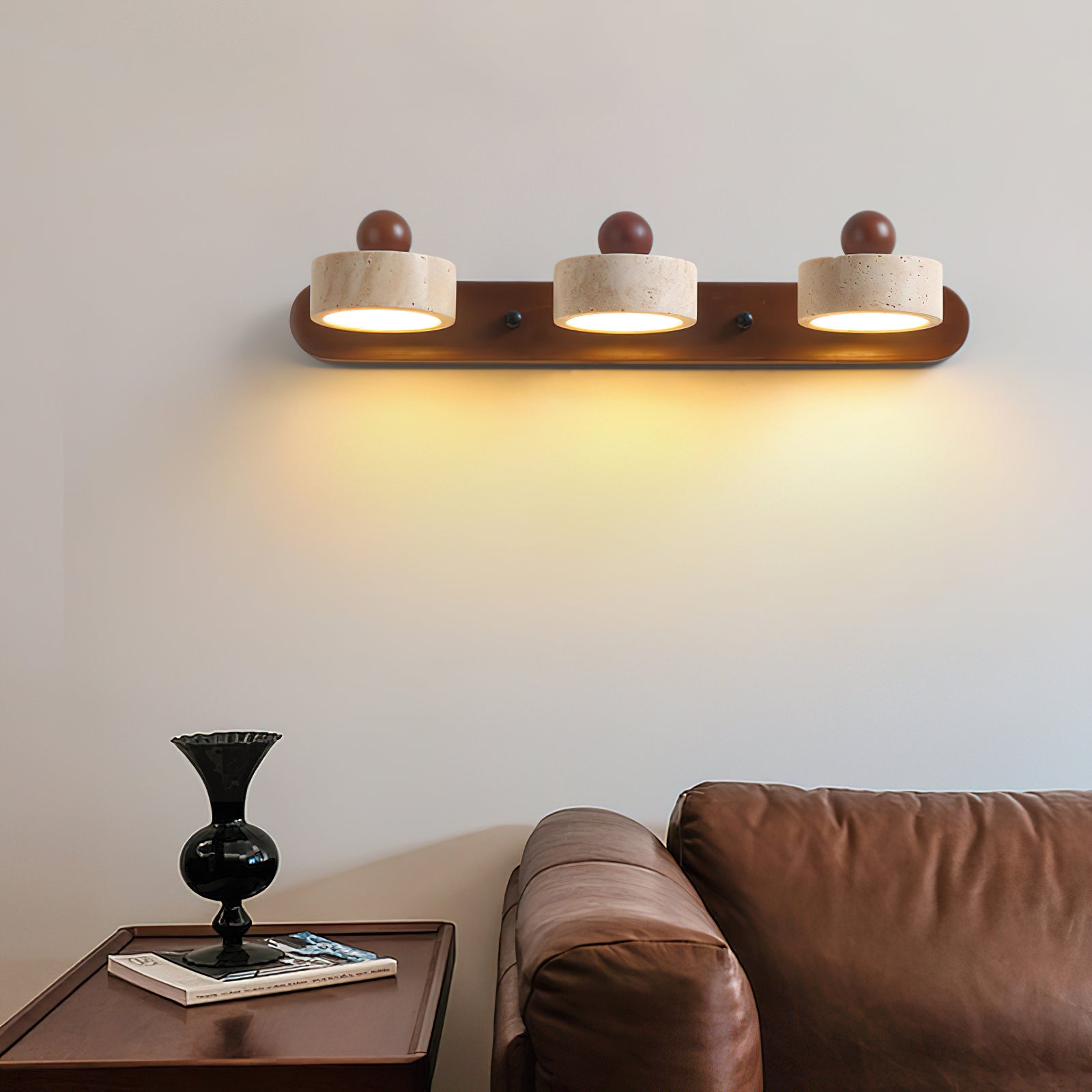 Close-up of the Piero Travertine Wall Lamp showing the stone and wood texture.