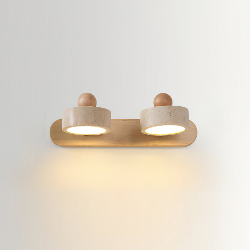 The 3-head lamp turned on, illuminating a wall with its warm light.