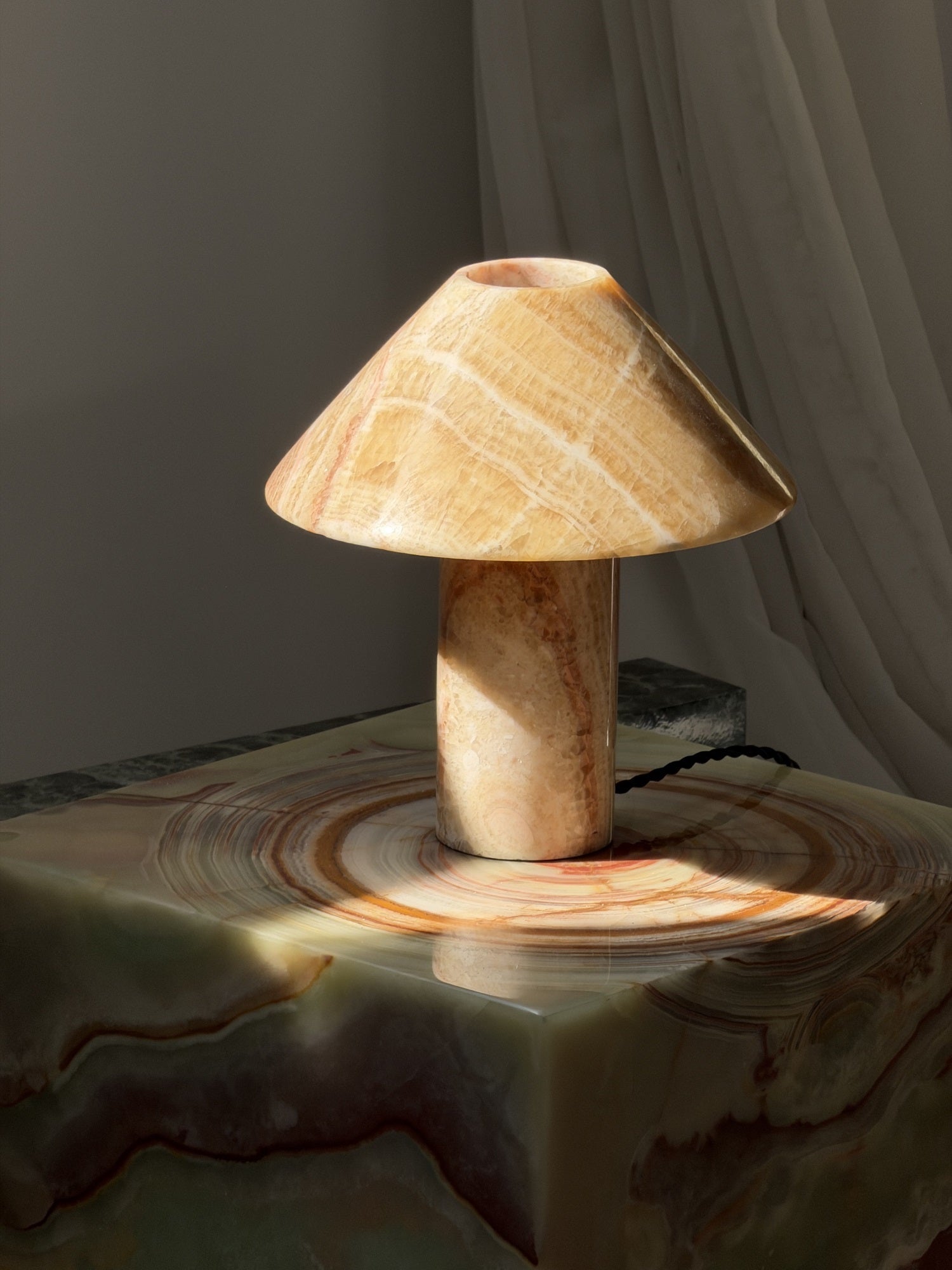 The warm ambient glow produced by the lamp.