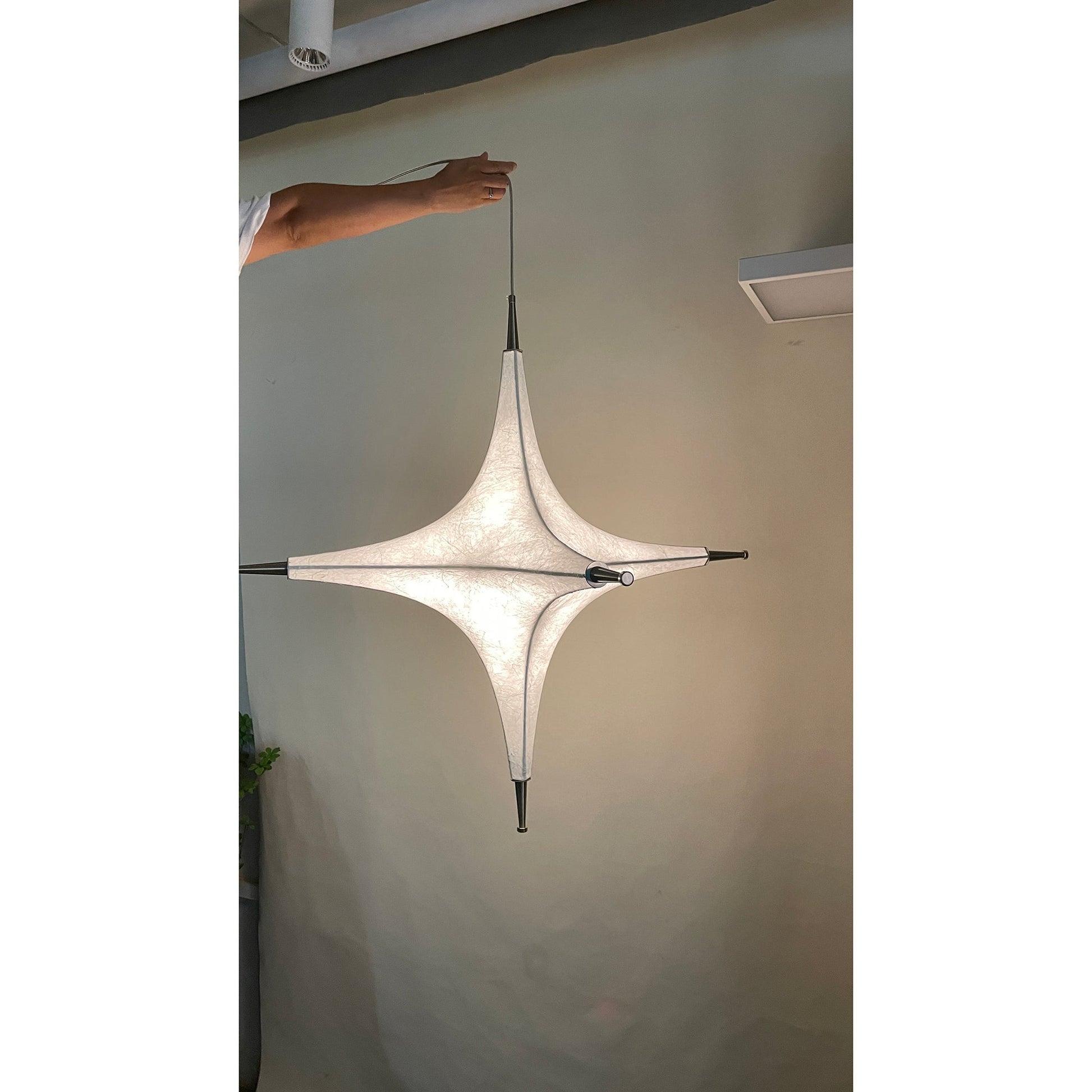 The black Polar Chandelier against a light-colored wall for a bold, contemporary look.