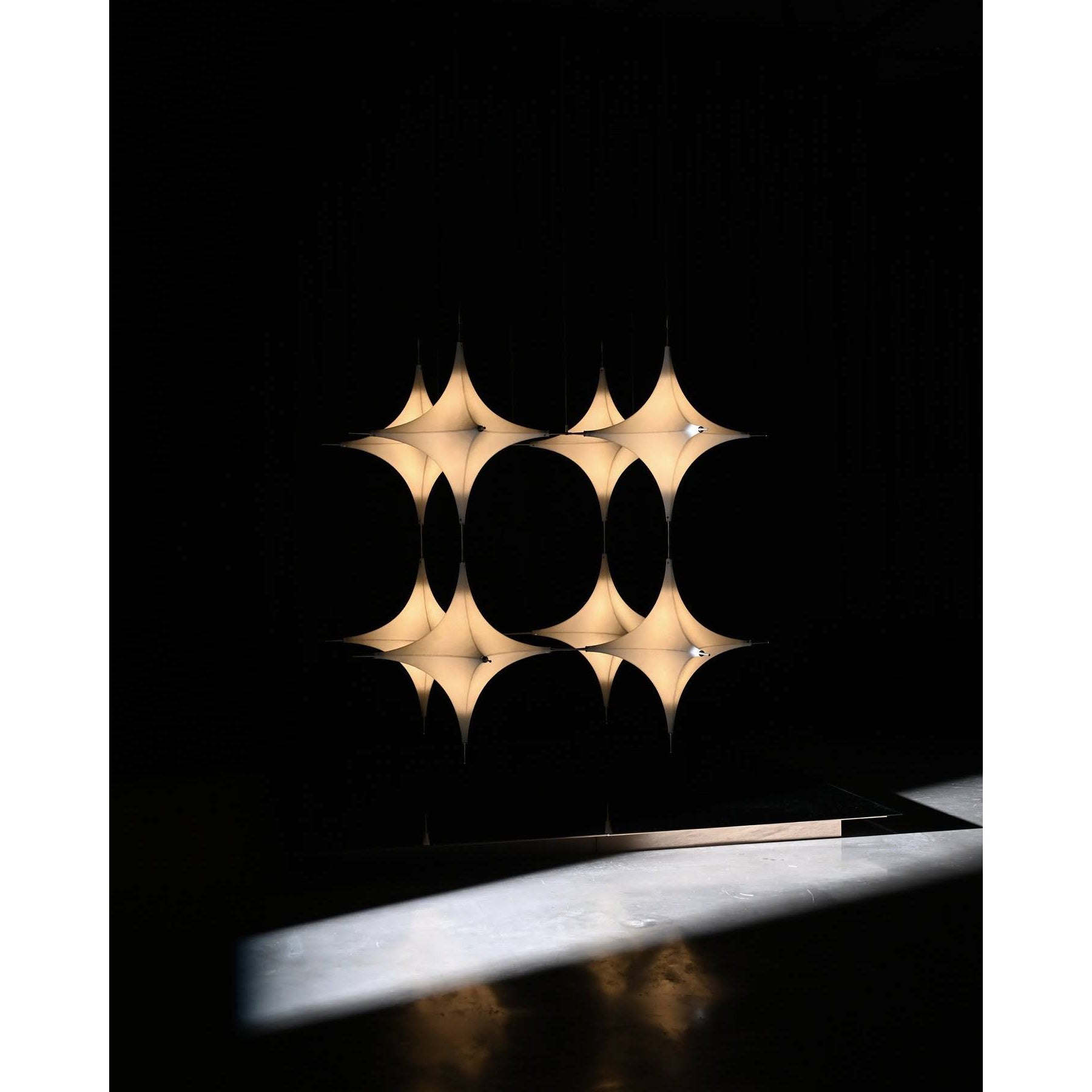 The large two-head Polar Chandelier as a statement piece in a high-ceiling entryway.