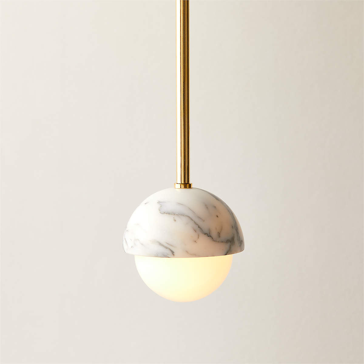 Close-up view of the white marble and brass details on the Polaris Pendant Lamp.