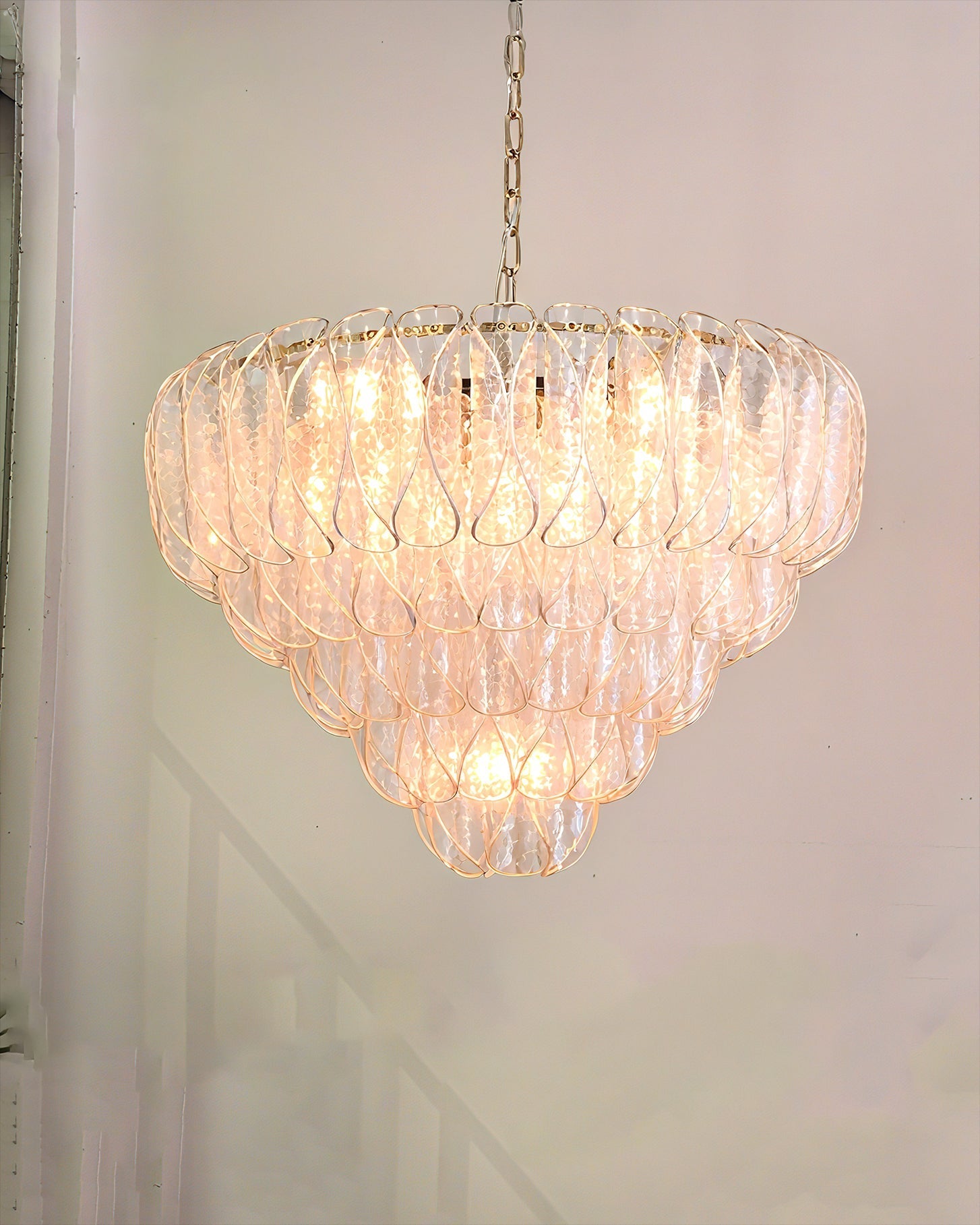 The Poliedri chandelier hanging in a modern living room, casting a warm glow.