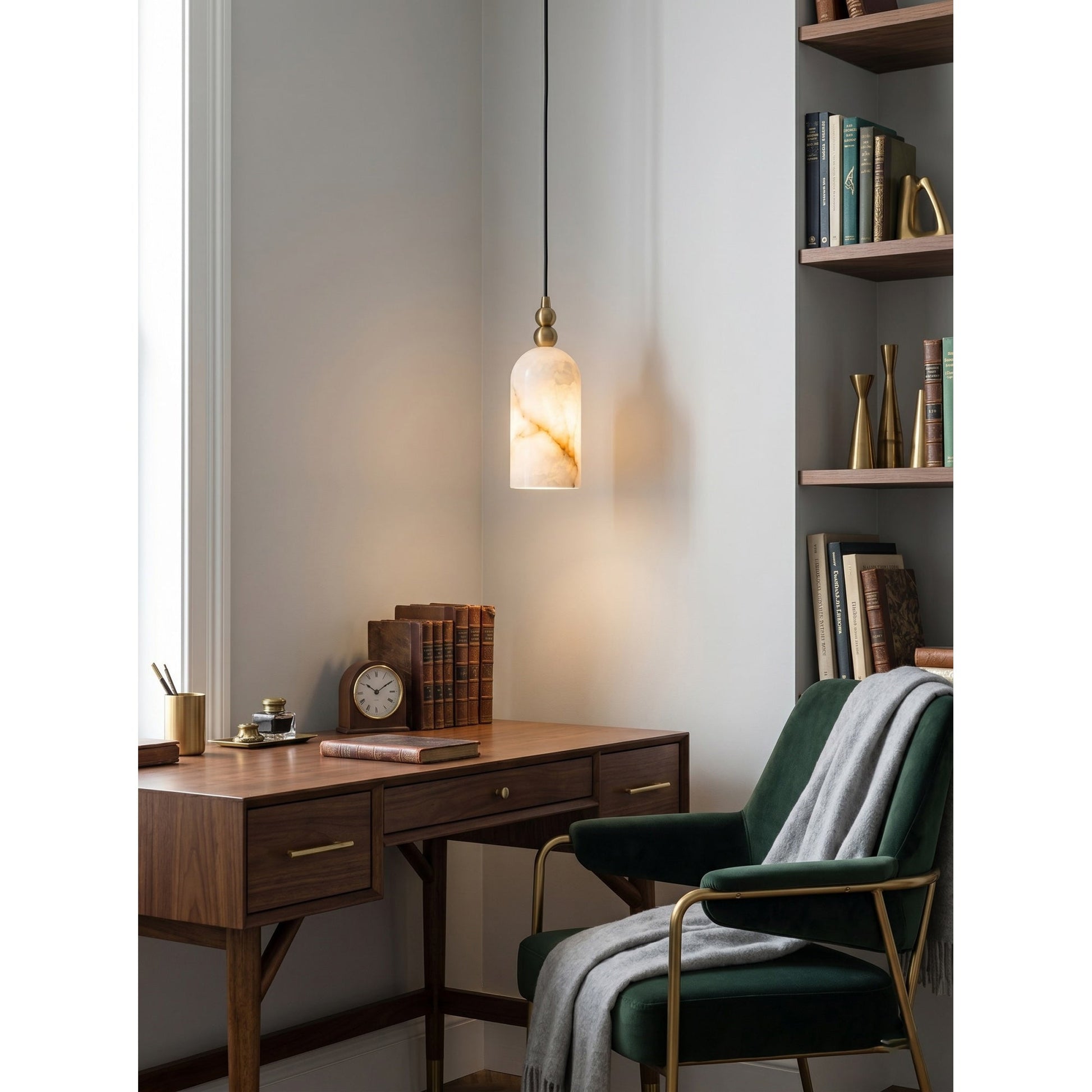 The pendant lamp unlit, showcasing the white alabaster and brass finish.