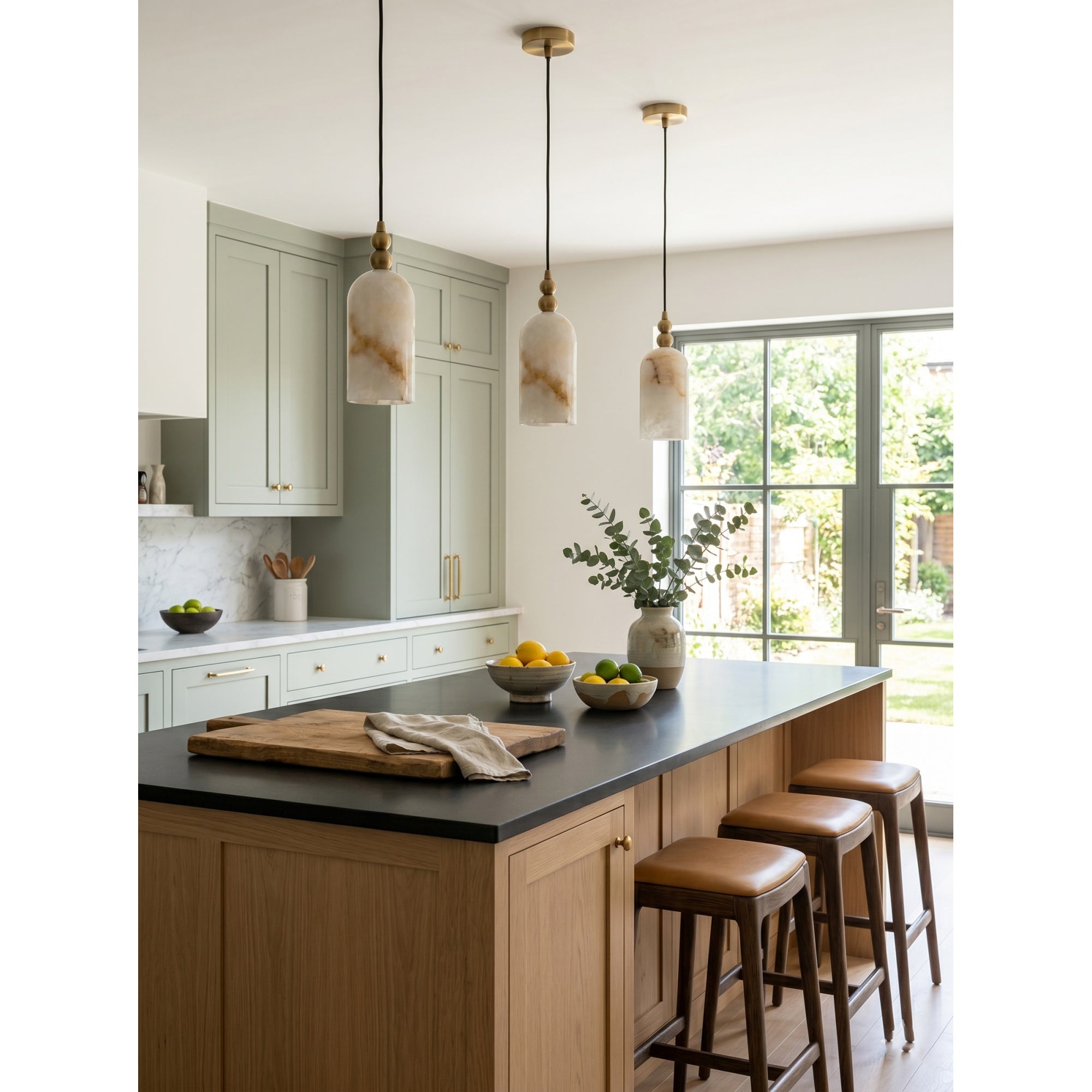 A pair of Pratt Alabaster Pendant Lamps hanging over a modern kitchen island.