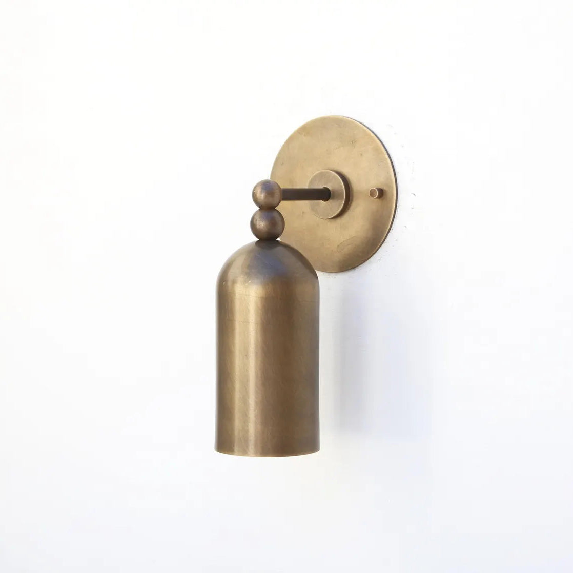 Lifestyle image of the Pratt Wall Lamp illuminating a hallway.