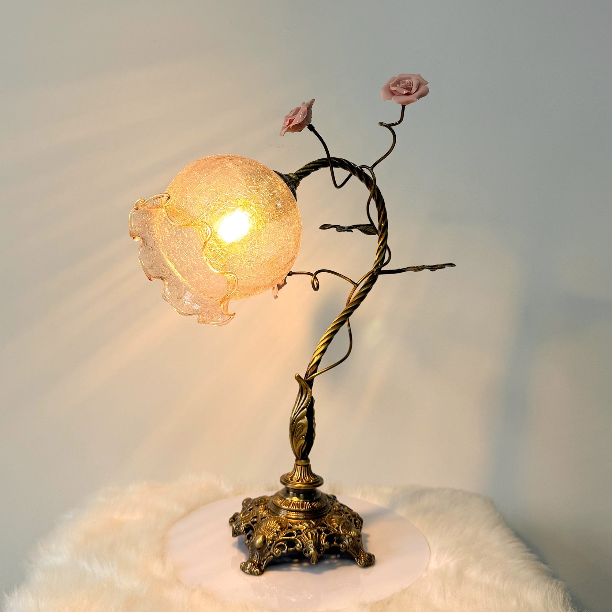 The Primavera Flowers Table Lamp placed on a study desk.
