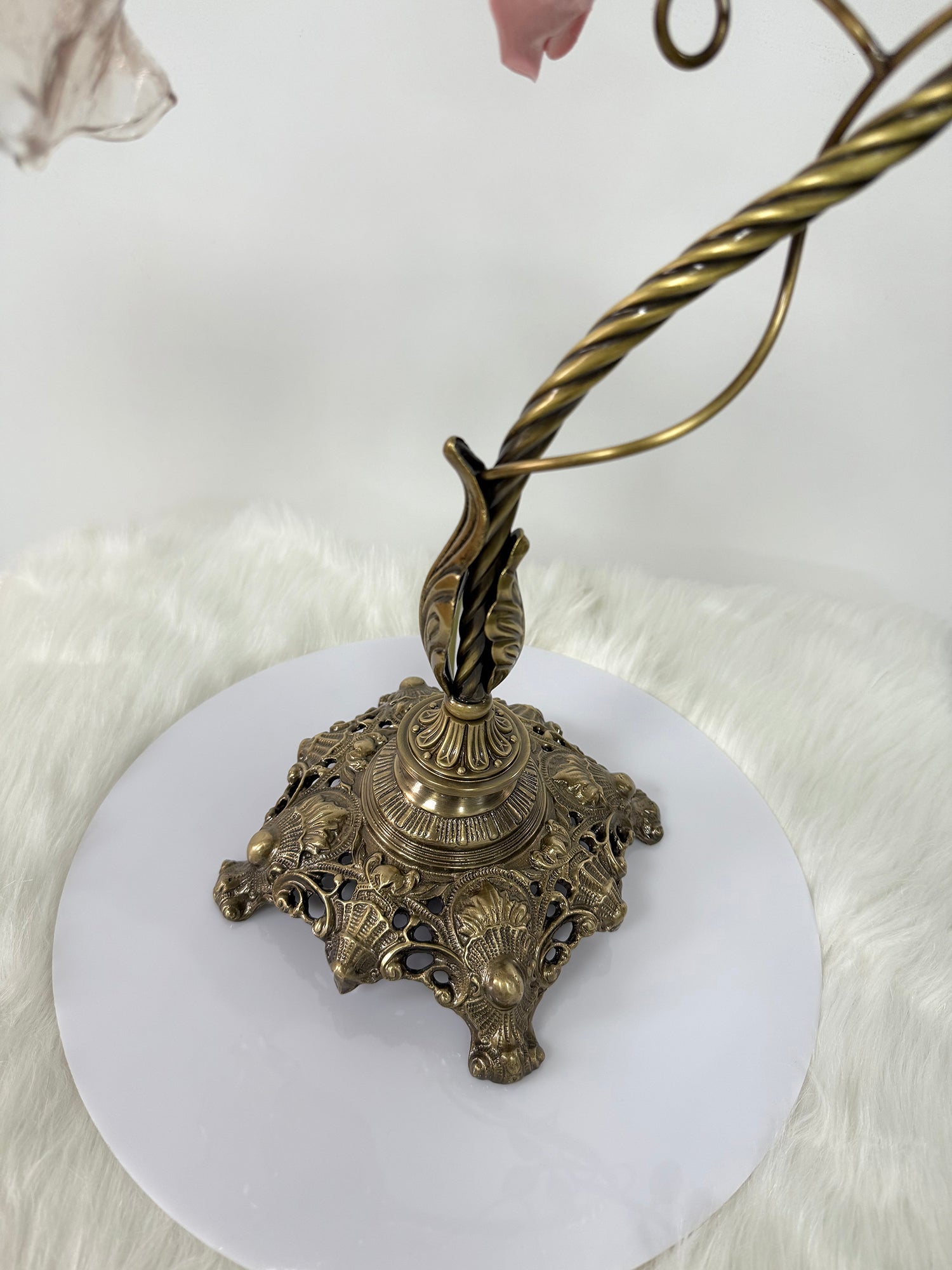 Detail showing the connection between the glass shade and the brass body.