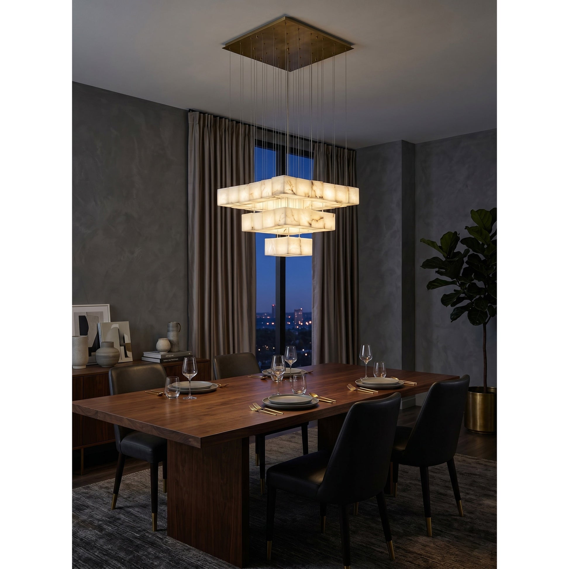 The warm, diffused light emanating from the Alabaster Box Chandelier.