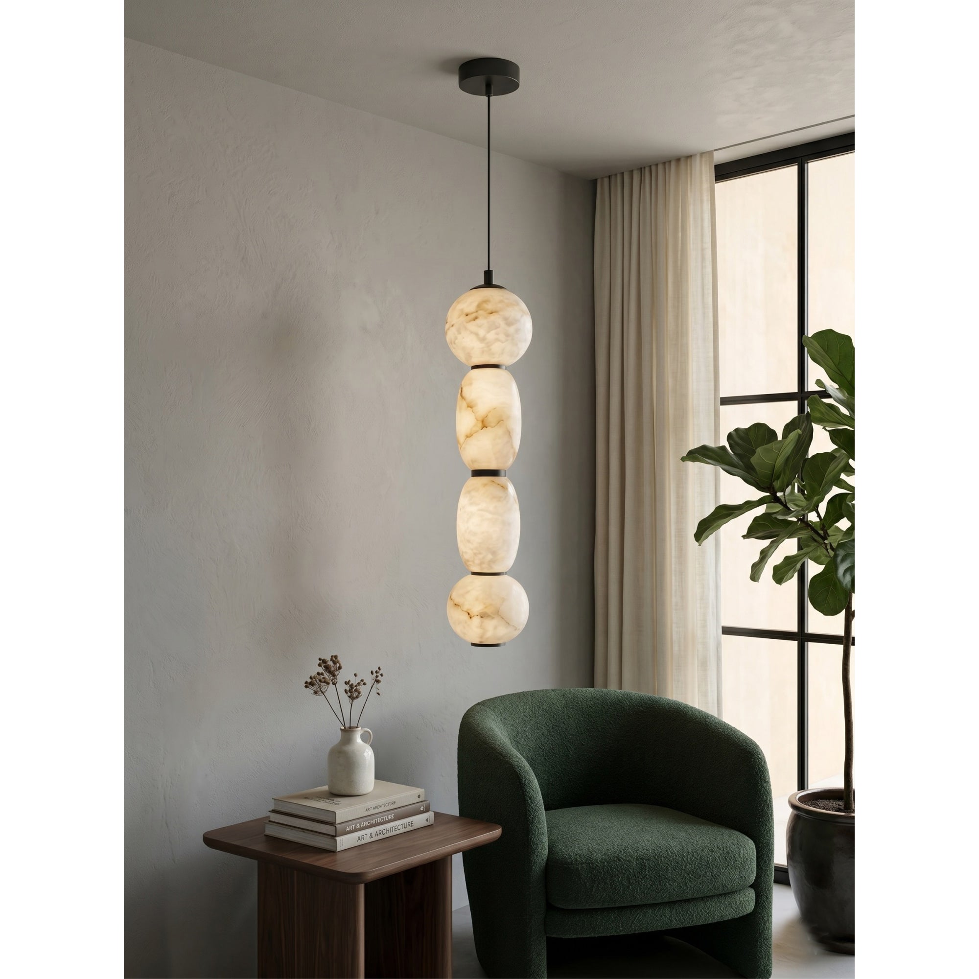 The 3-head version of the alabaster pendant lamp against a dark wall.