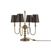 Alden Table Lamp in antique brass finish on a console table.