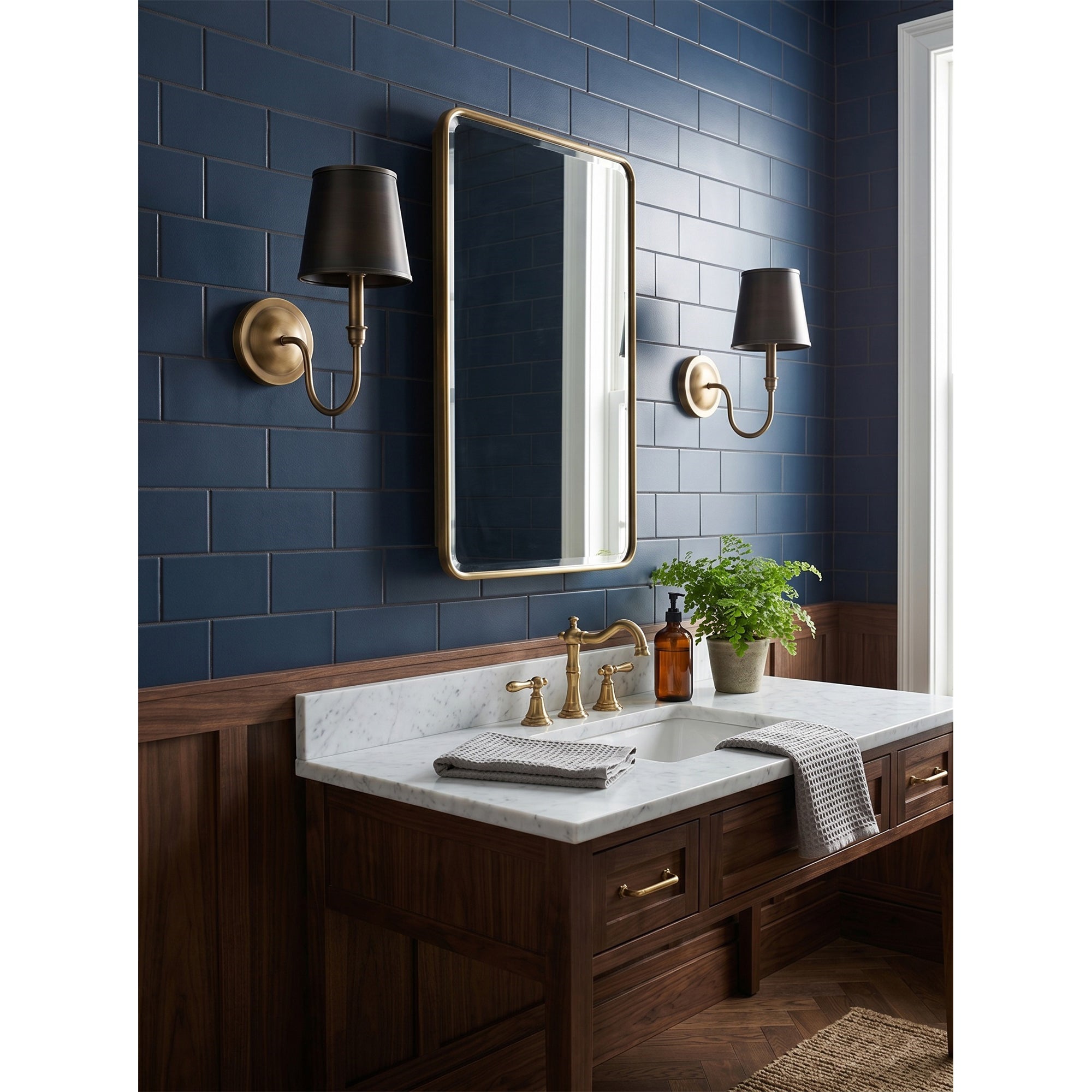 The Alden Wall Sconce illuminated, casting a directed downward glow.