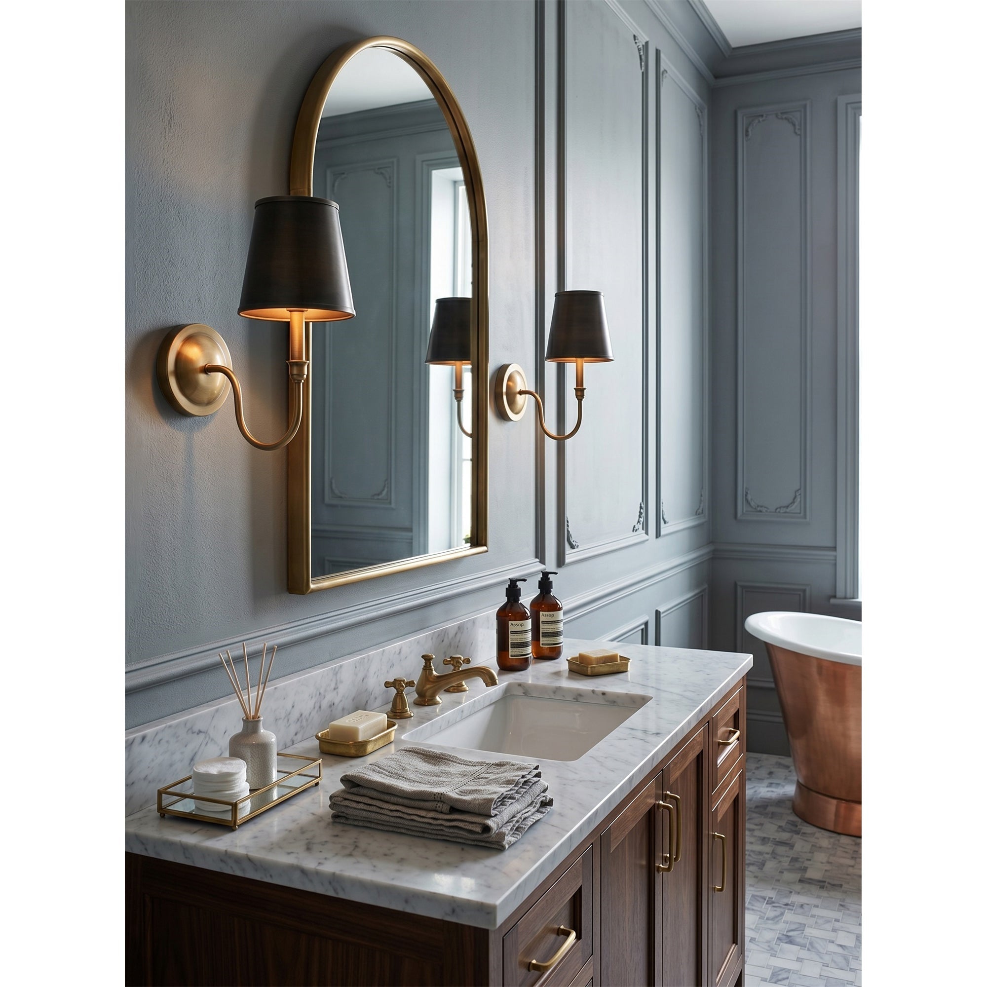 The Alden Wall Sconce providing warm light in a home library.