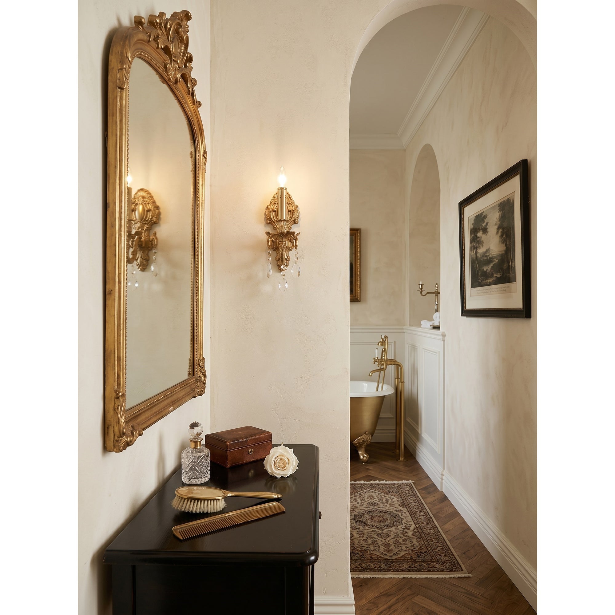 Lifestyle image of the Aldepo Wall Sconce in a grandmillennial-style bedroom.