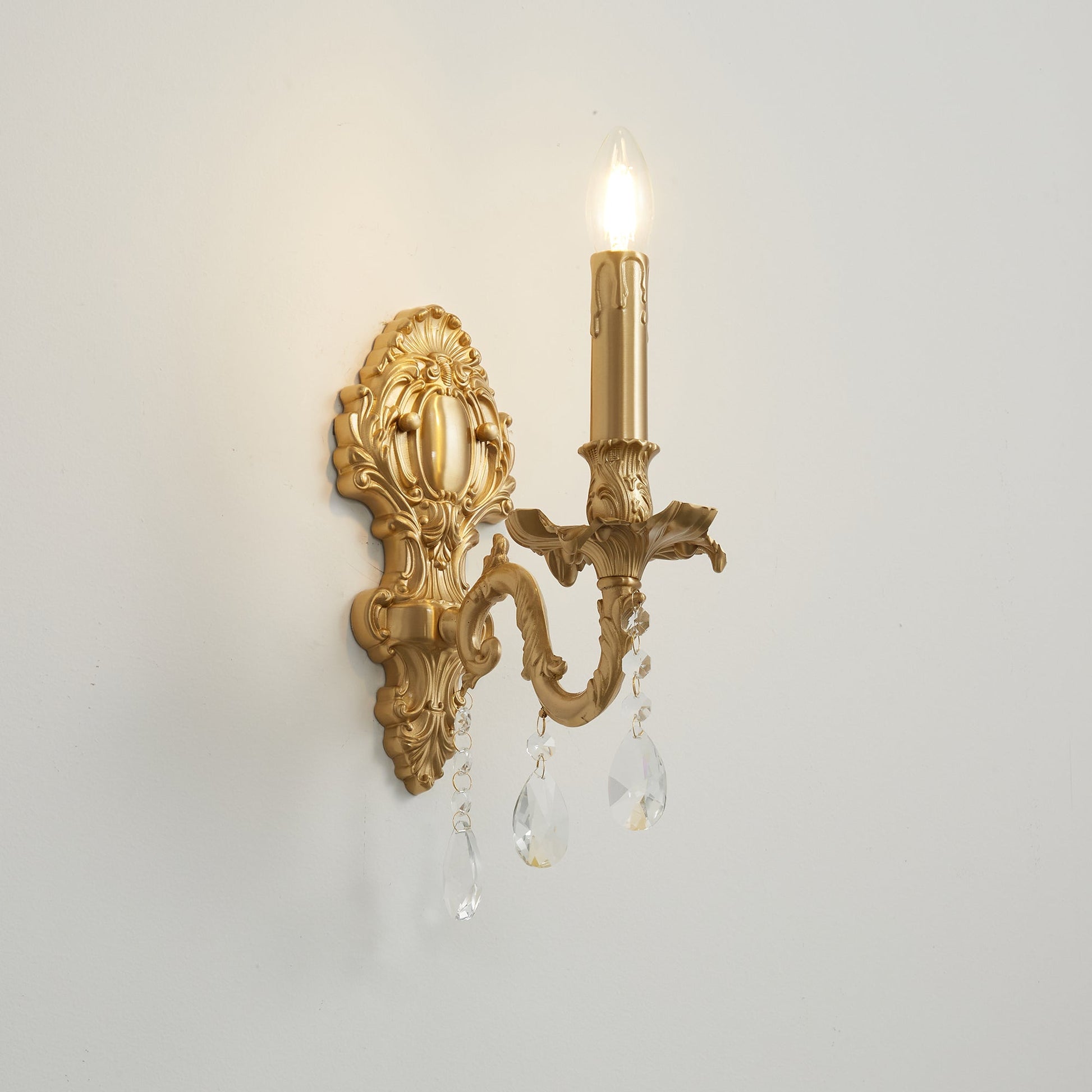 Aldepo Wall Sconce against a dark, dramatic wall color.