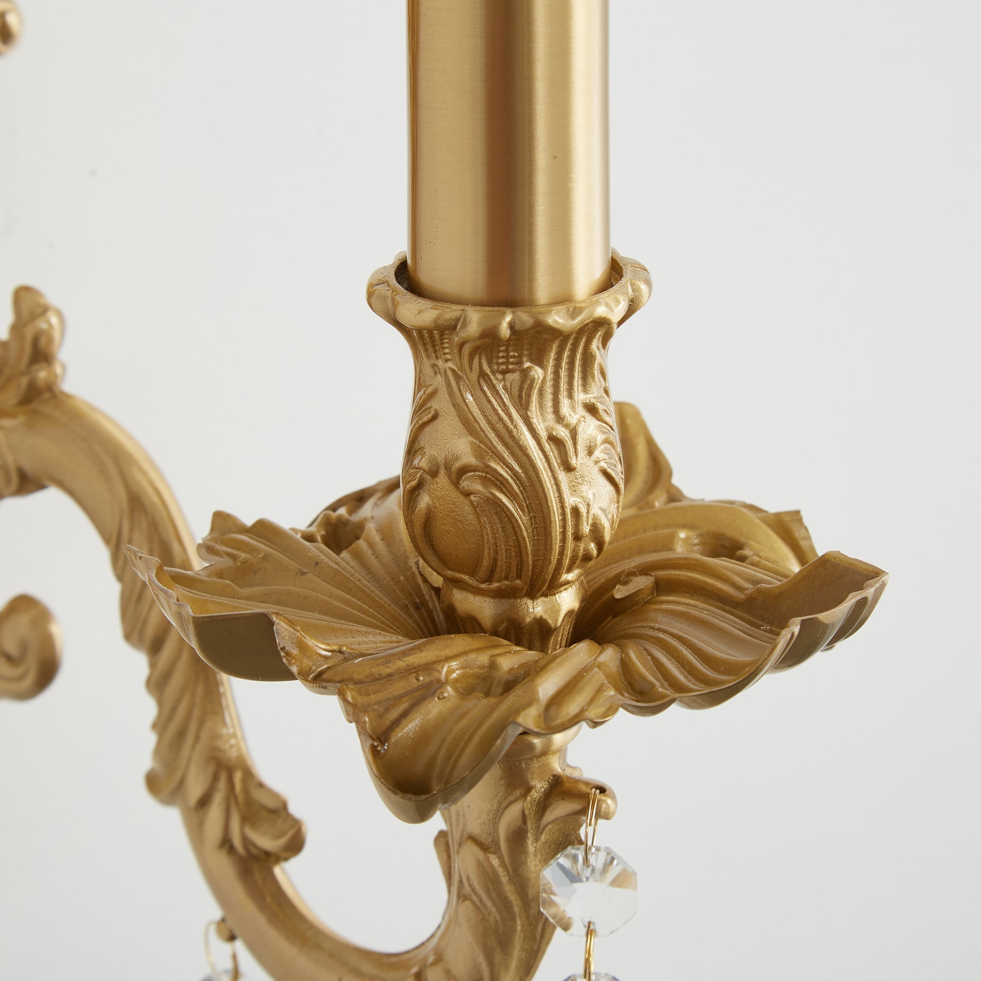 The sconce's brass finish catching the light.