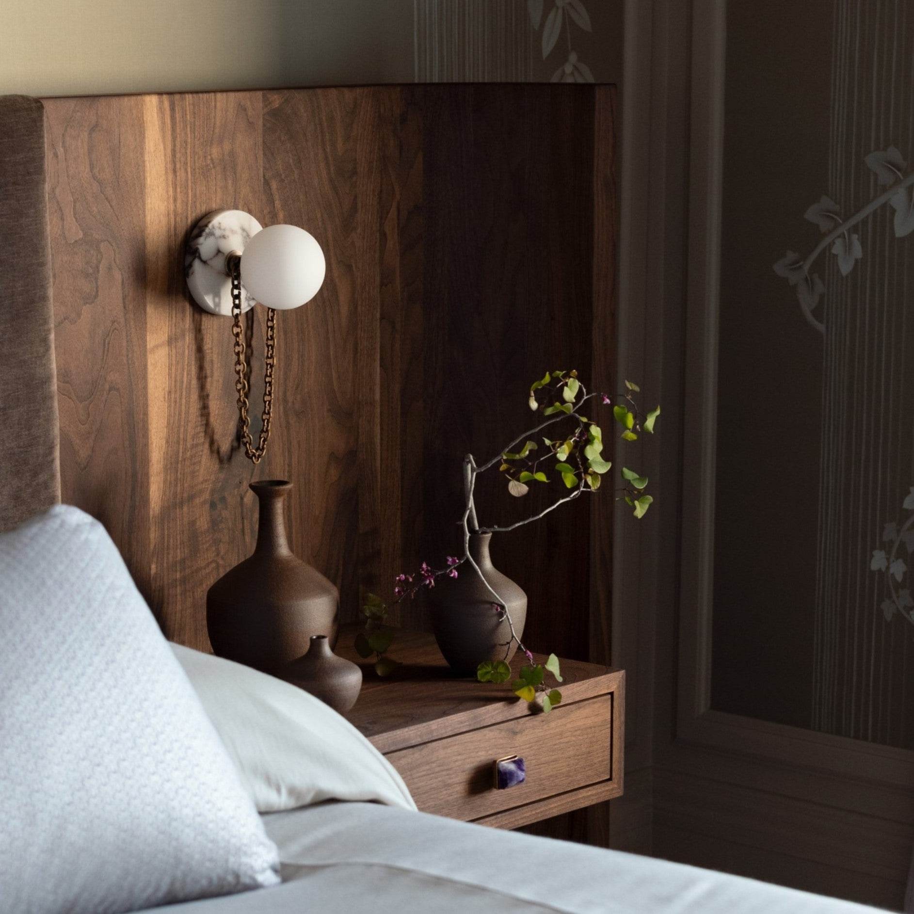 The Alla Wall Sconce with a black marble backplate.