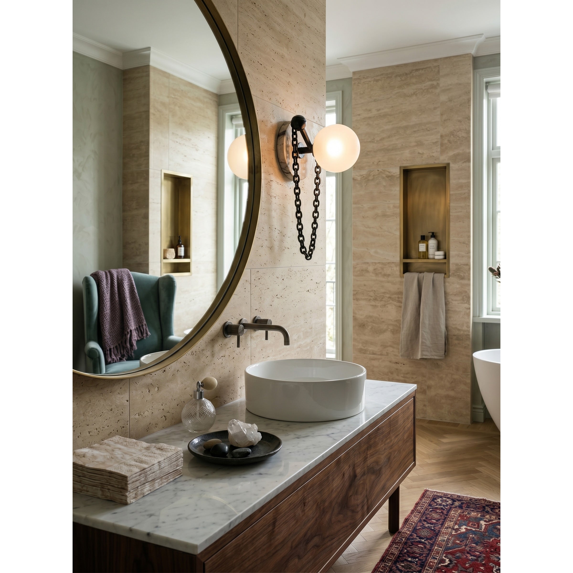 The Alla Wall Sconce with a beige travertine backplate.