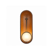 Aperture Wall Sconce with walnut wood backplate and antique brass stem.