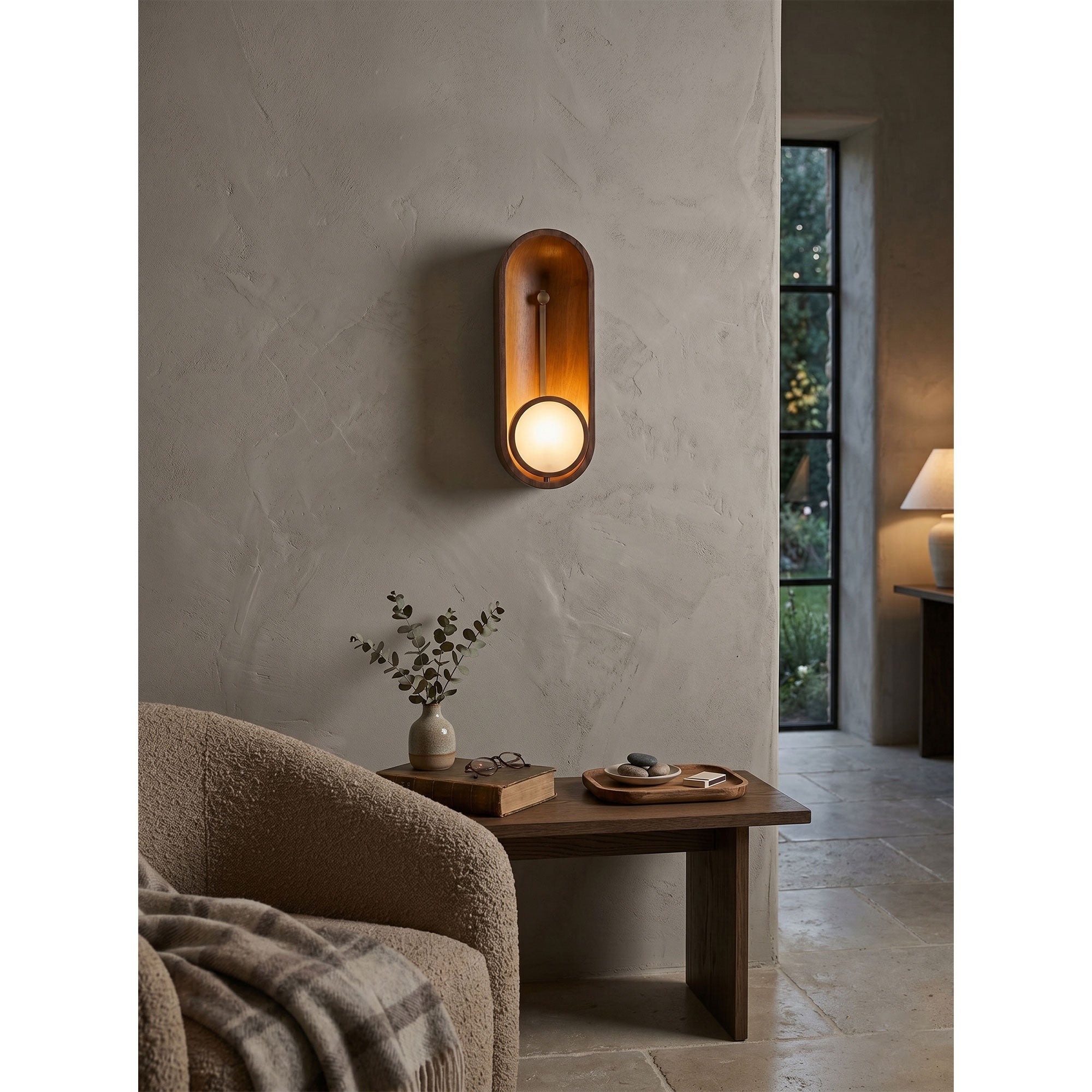 Aperture Wall Sconce used as a stylish bedside reading light.