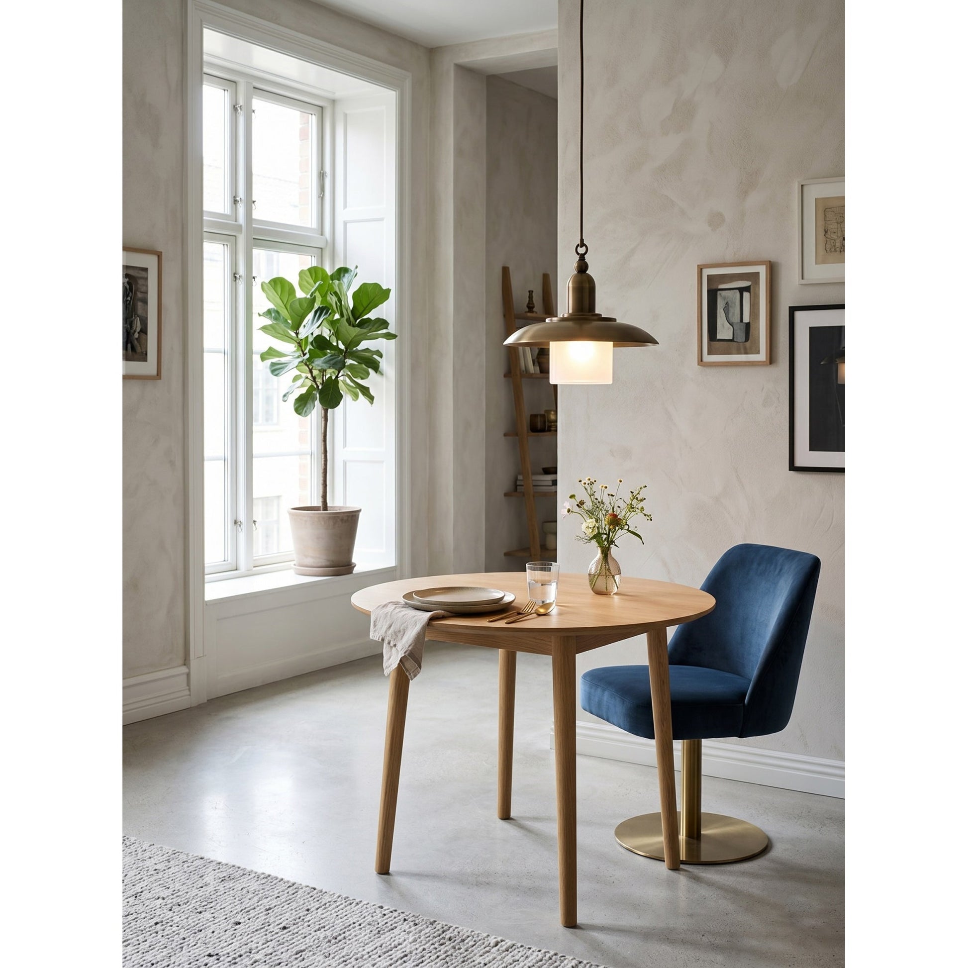 A pair of Argent Pendant Lamps above a wooden dining table.